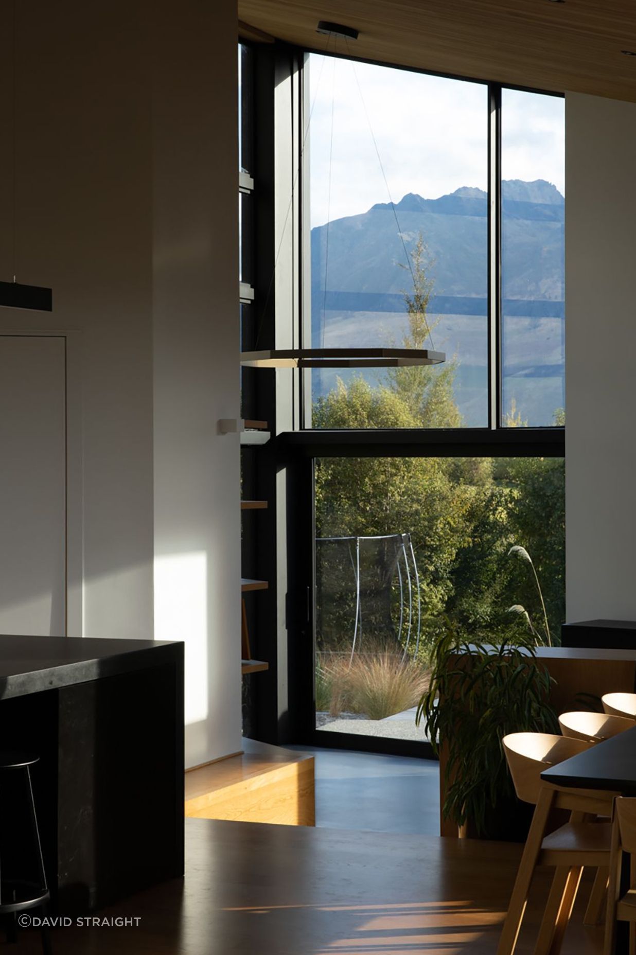 The pantry door on the left opens up with glazing to reveal a landscape view.