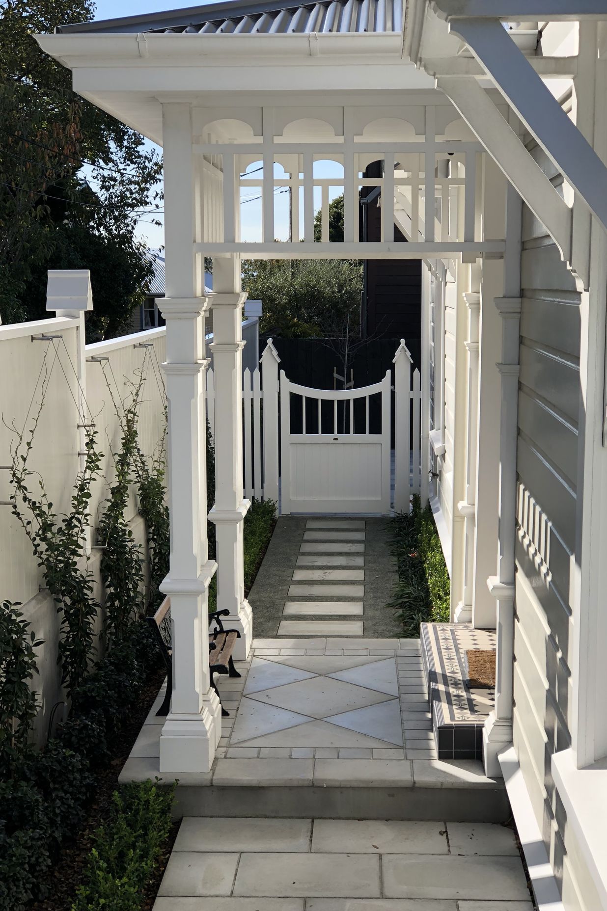 A jasmine espalier trained on stainless steel wires runs length of the new side fence