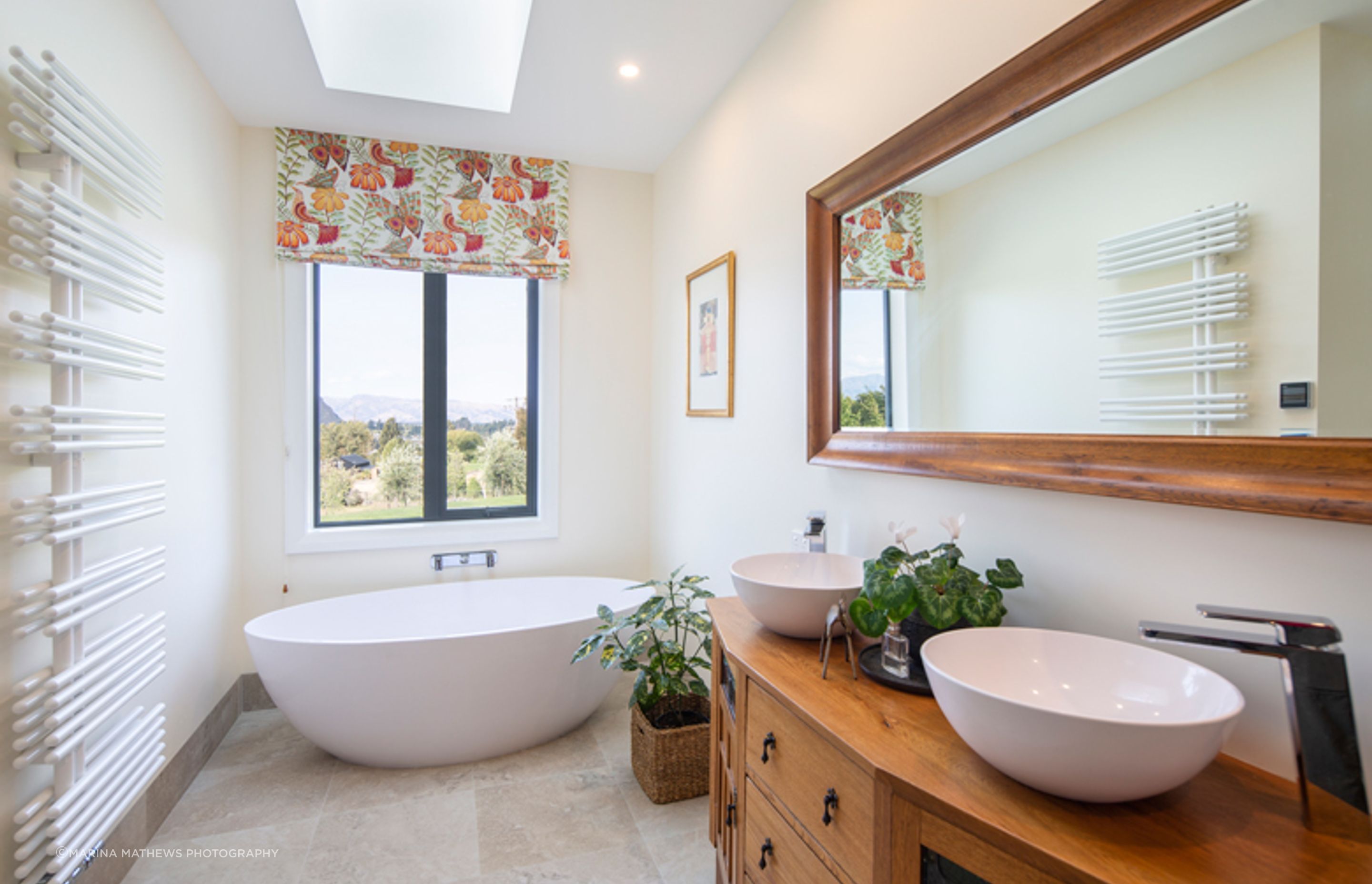 The family bathroom is a light and generous space with views towards the Southern Alps in the distance.