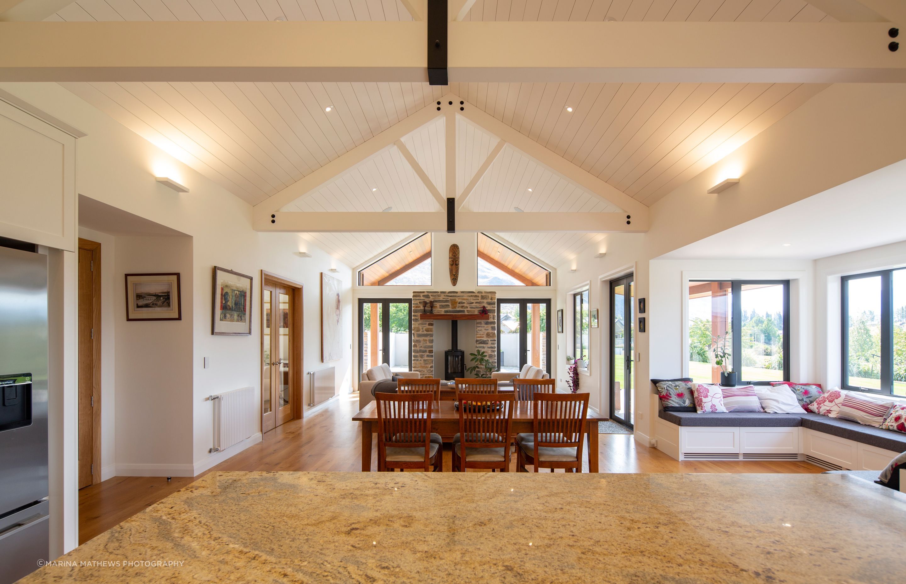 Timber trusses and sarking continue the traditional-style architecture seen on the exterior. The painted ceiling helps reflect light back into the room and contributes to the light and airy feel of the spaces.