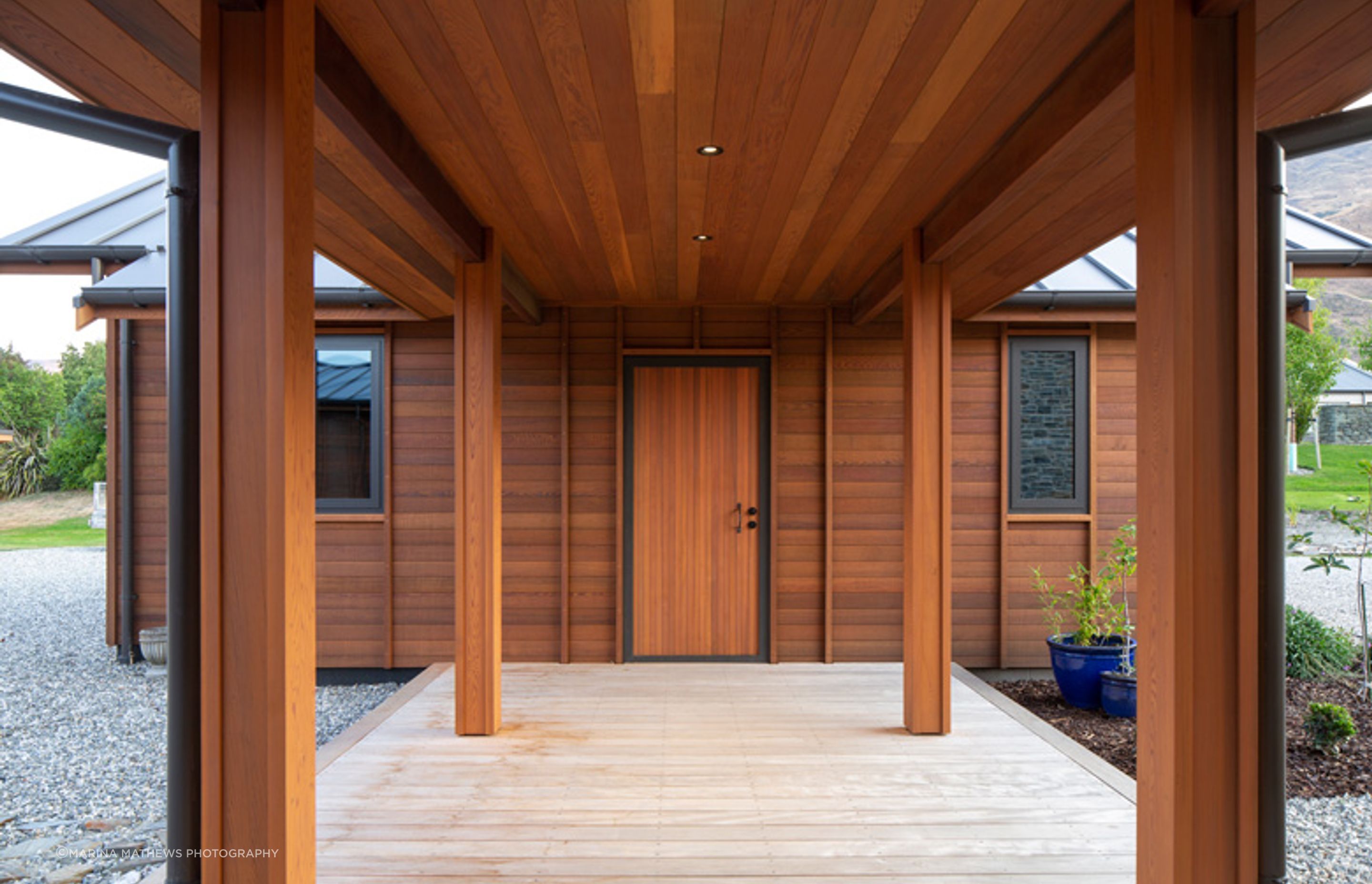 A covered walkway links the separate garage, with mudroom facilities, to the main house.