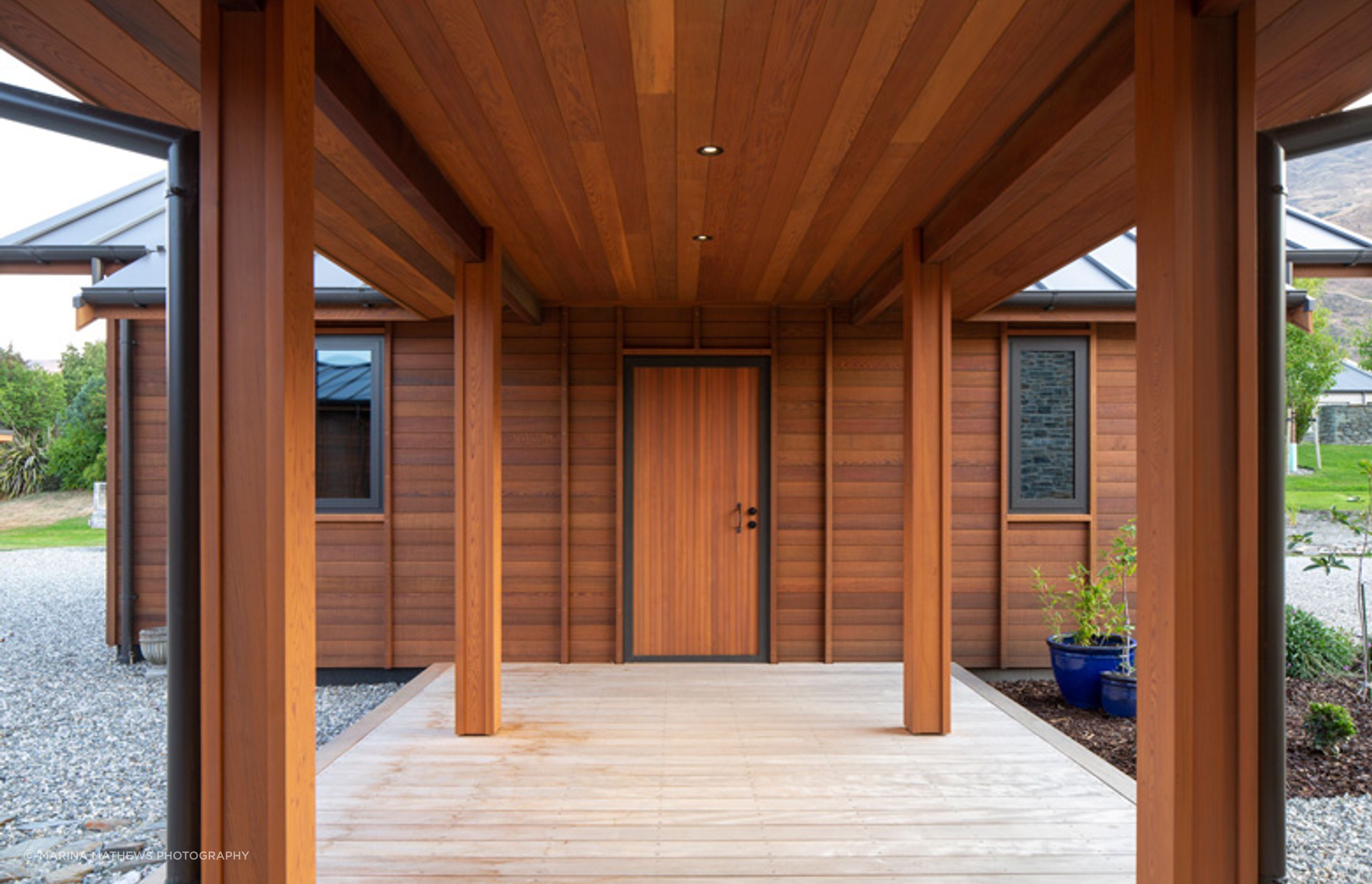 A covered walkway links the separate garage, with mudroom facilities, to the main house.