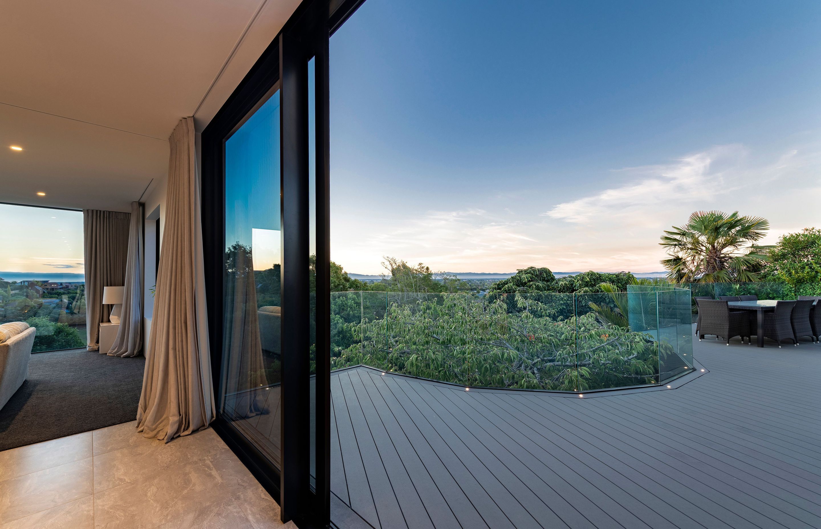 Sliding doors open the tiled living spaces up to the view and the horizon in the distance.