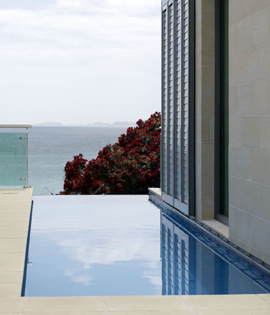 Lap pool adjacent to stone clad wall