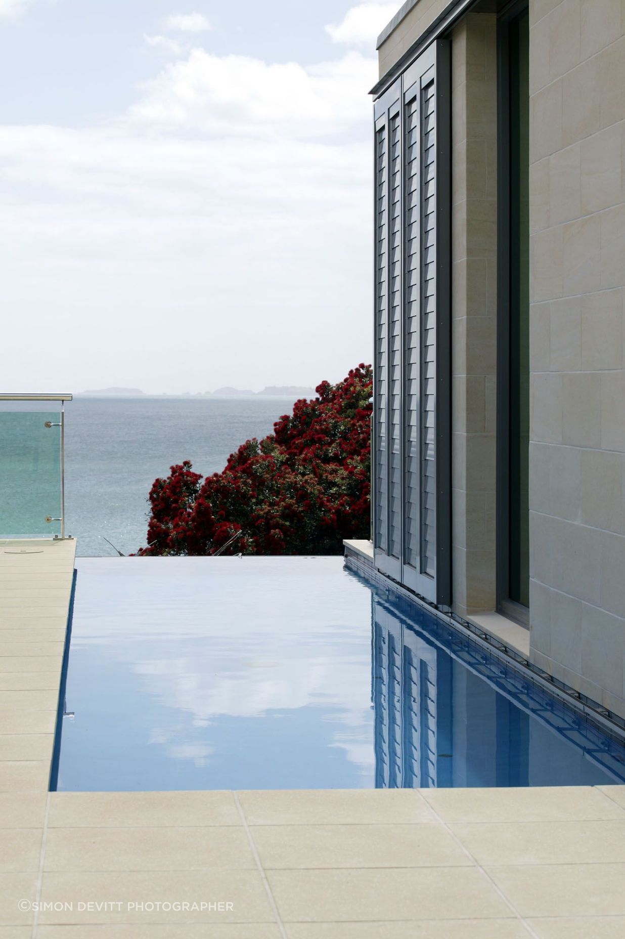 Lap pool adjacent to stone clad wall