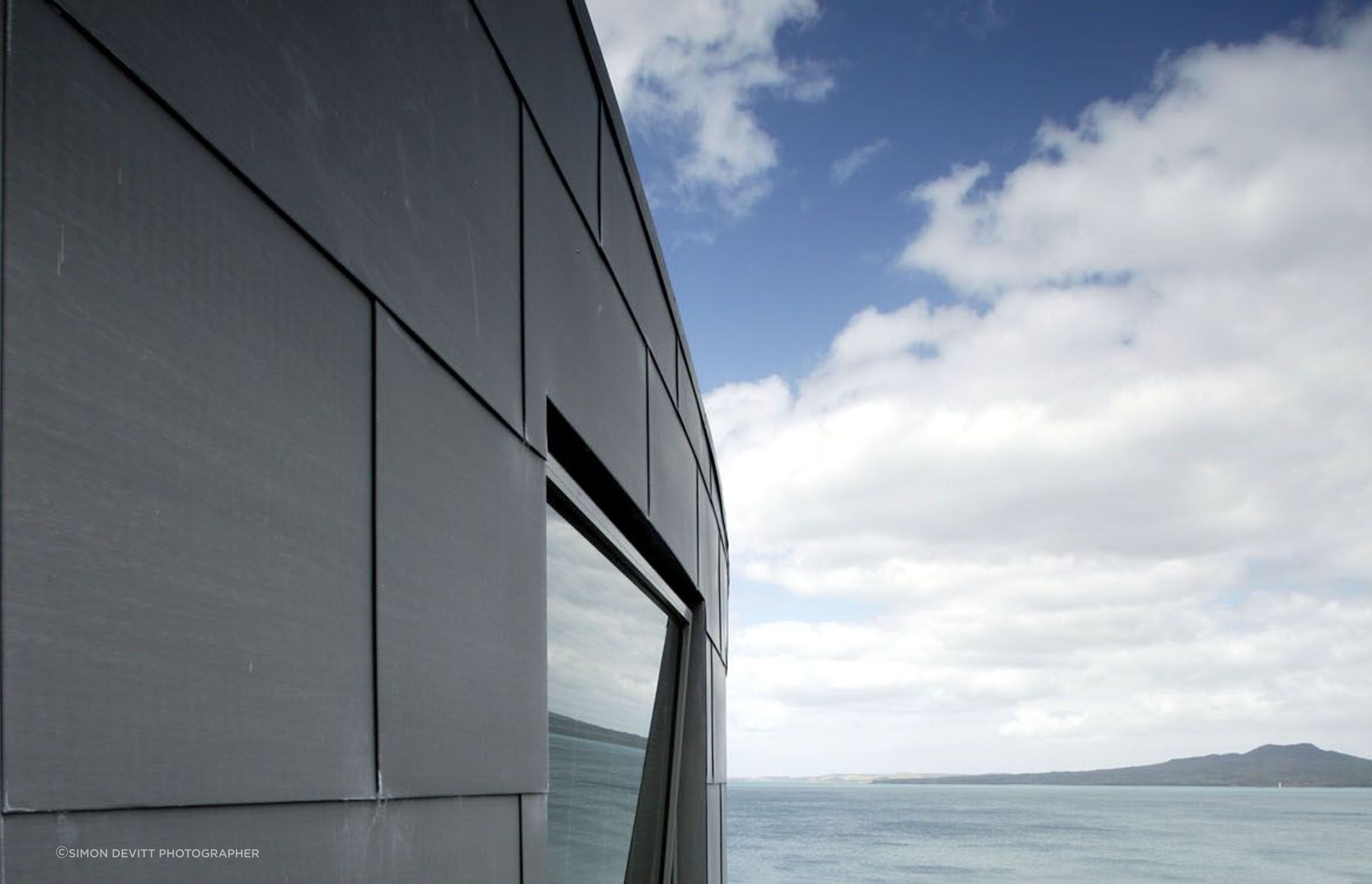 Curved zinc cladding of upper level looking towards Rangitoto Island