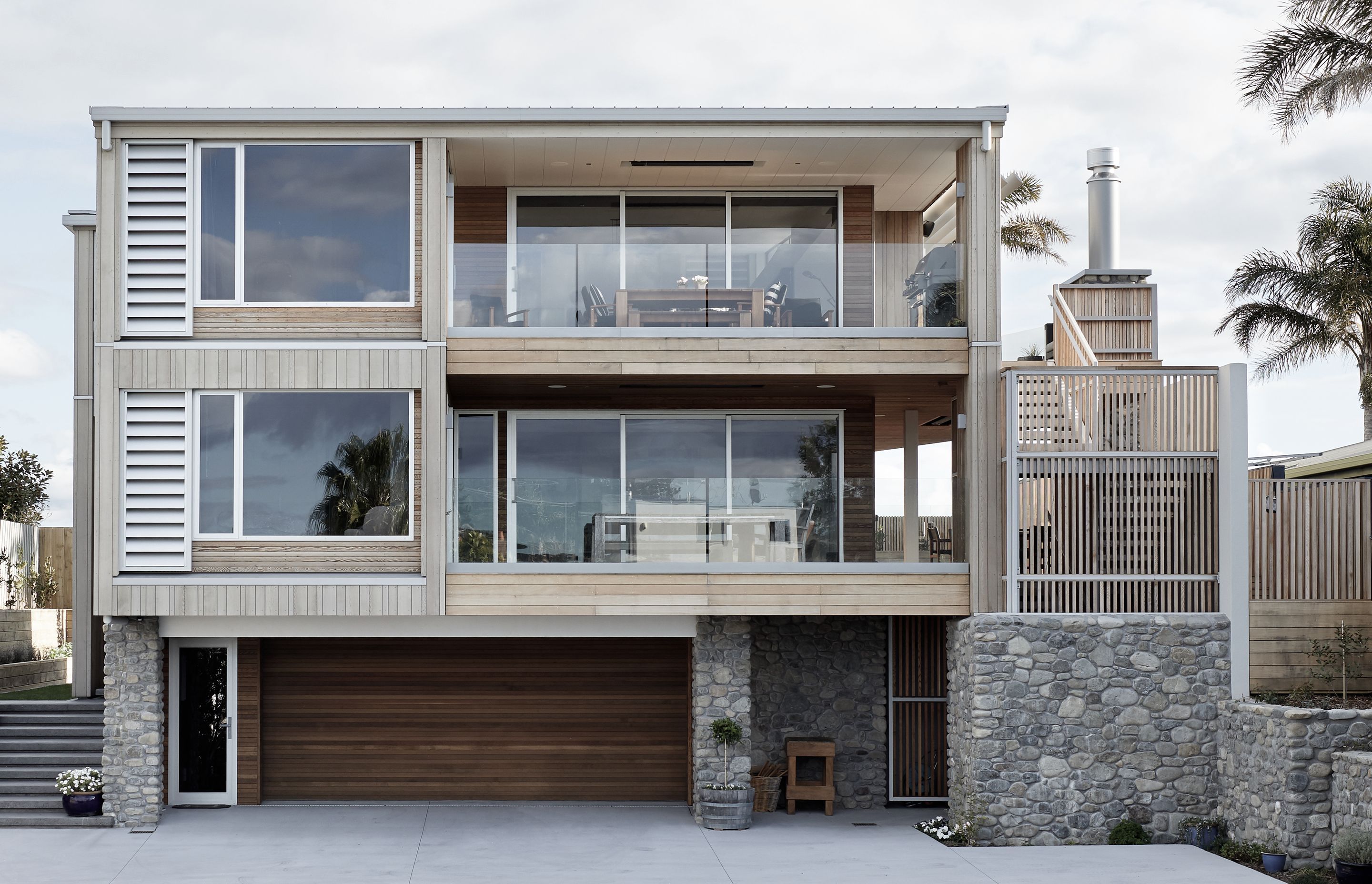 Designed to accommodate multi-family living, this house comprises a two-bedroom 'apartment' on the top floor, where the owners live and a three-bedroom, self-contained 'house' on the middle floor for visiting family and friends.