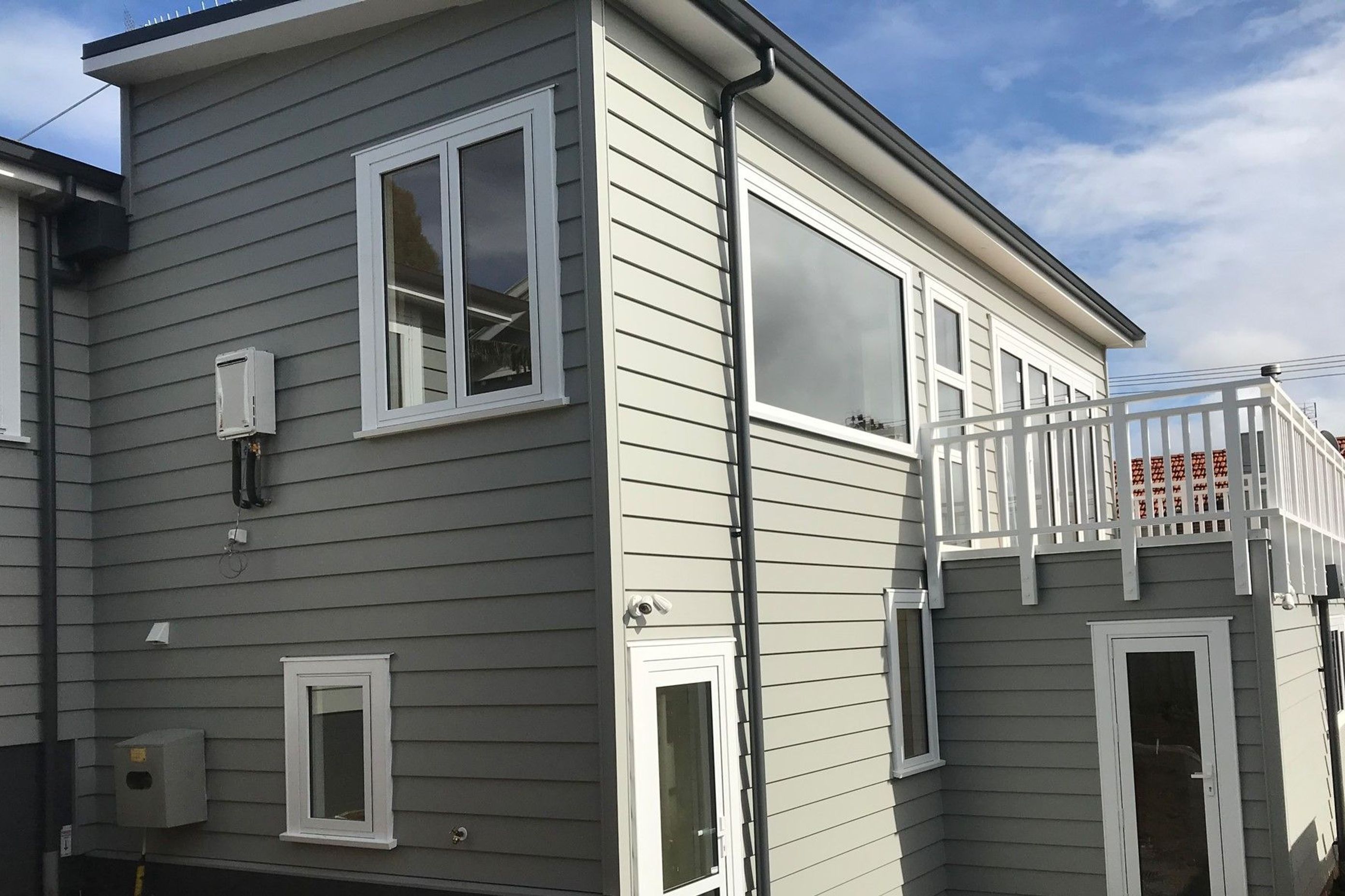 On the upper level the  existing lounge was pushed out over the new garage and large bifold doors out onto the new deck.