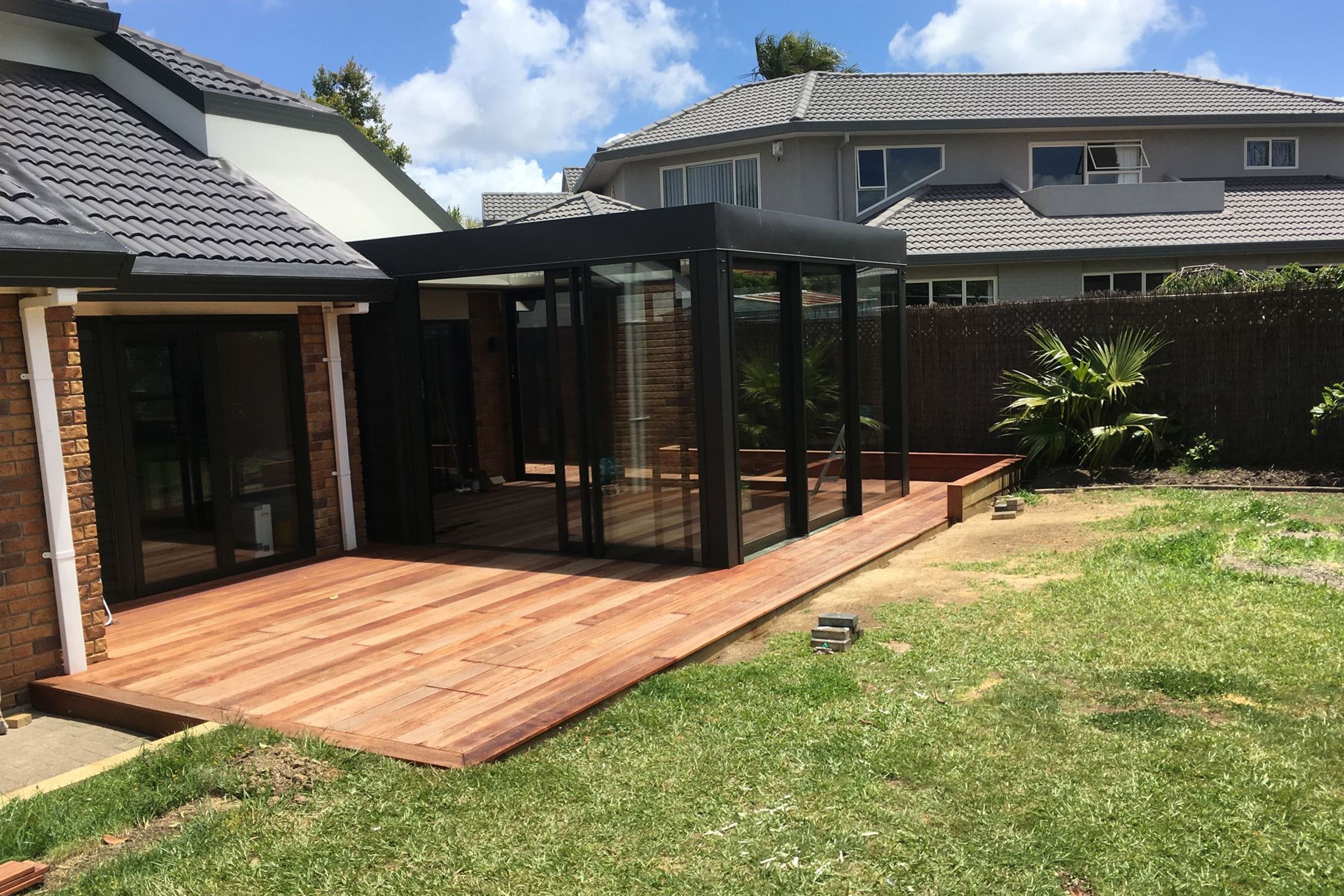 A new deck and also an enclosed entertainment area with a louvre roof.