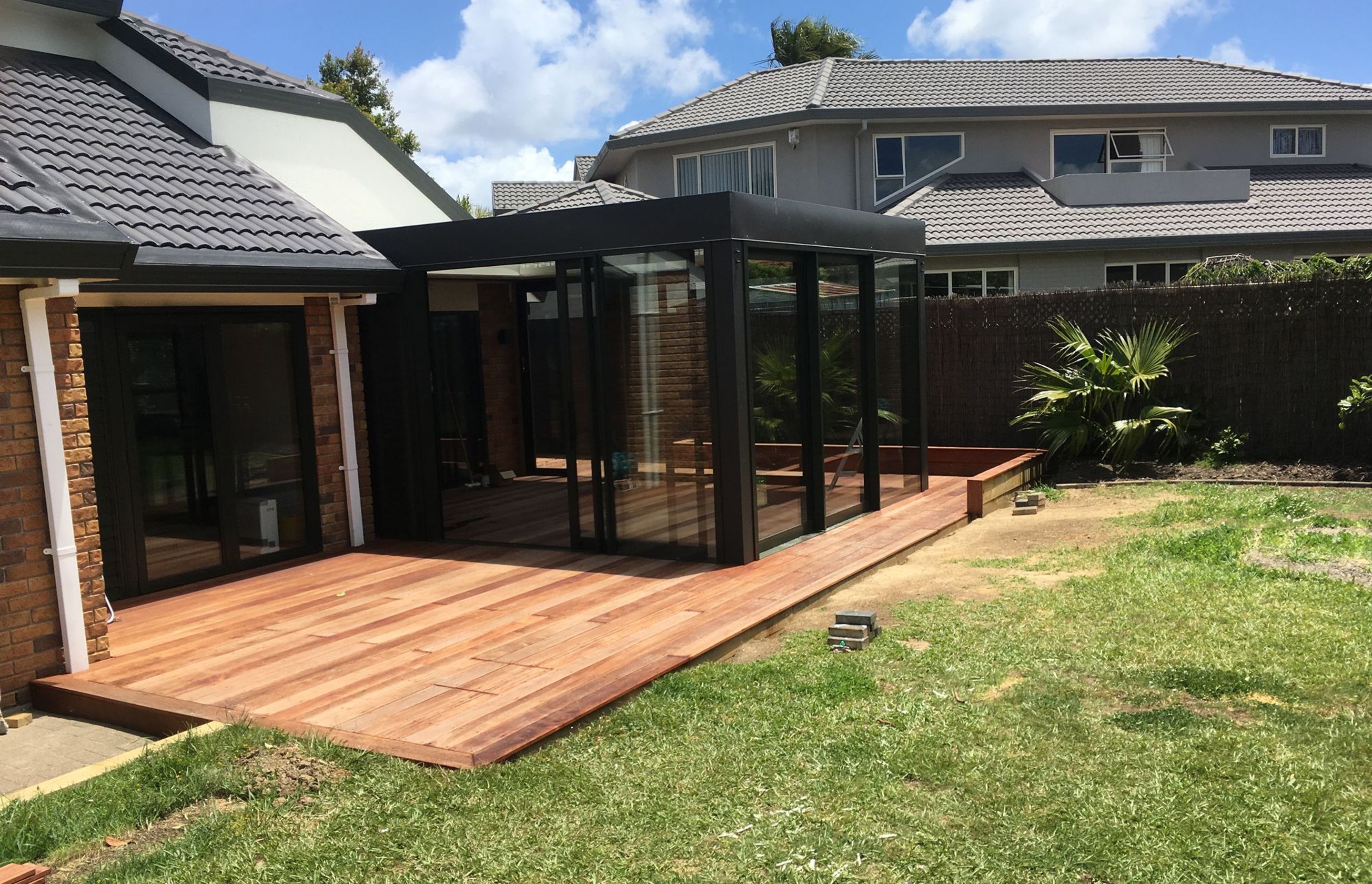 A new deck and also an enclosed entertainment area with a louvre roof.