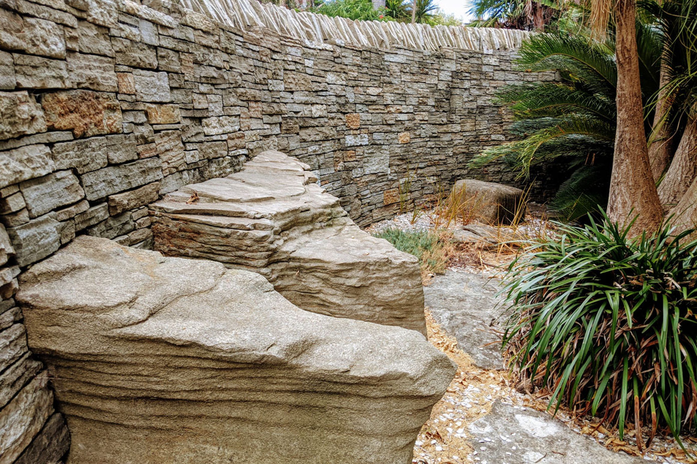 Curved stone wall with feature rocks