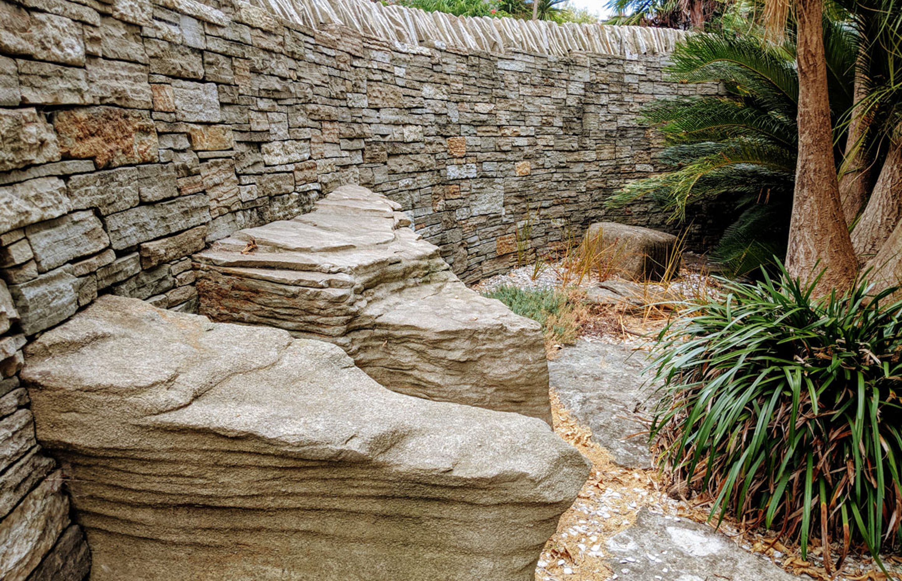 Curved stone wall with feature rocks