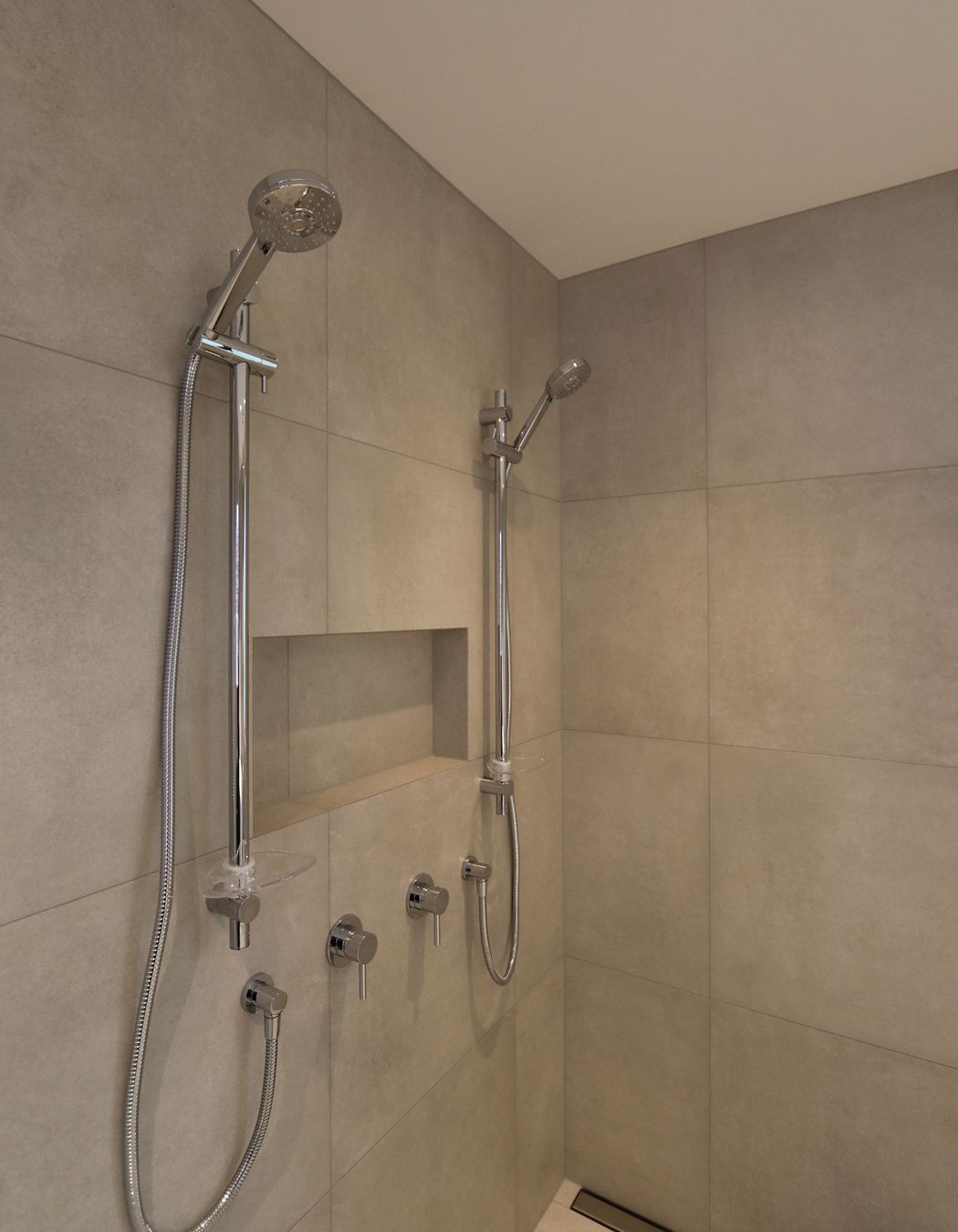 Large double shower in the main bathroom with a discreet channel drain.