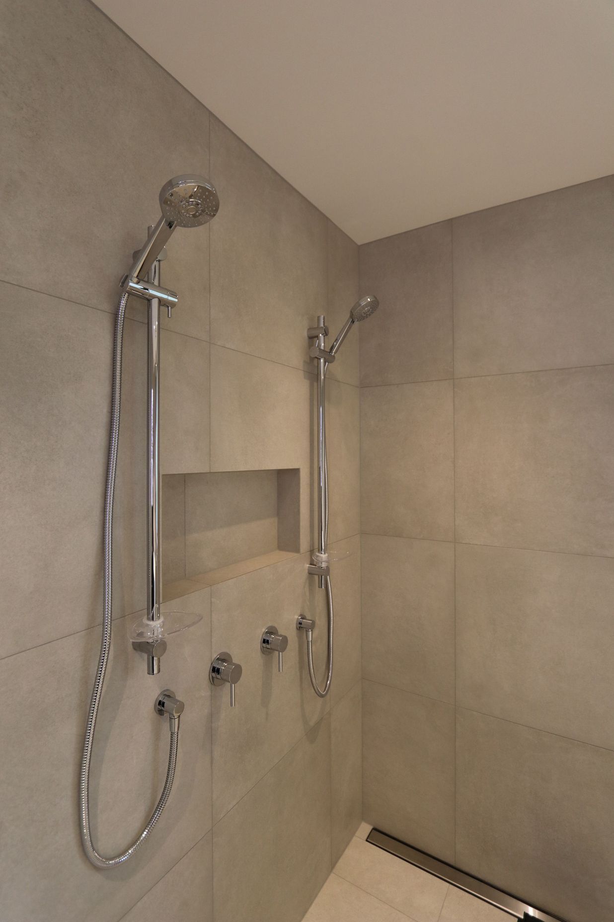 Large double shower in the main bathroom with a discreet channel drain.