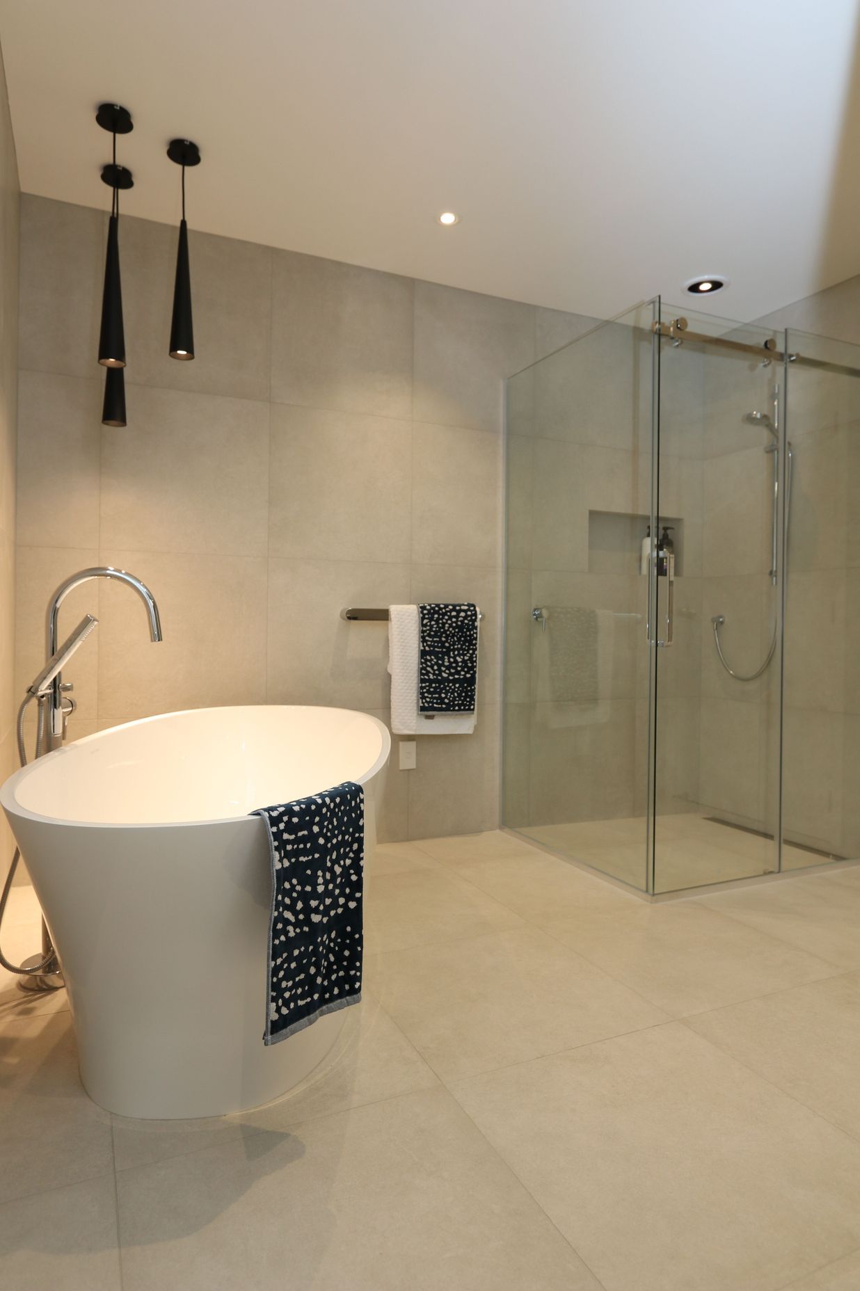 The main bathroom exerts just as much wow-factor as the ensuite with its large frameless glass shower and luxurious bath set-up.