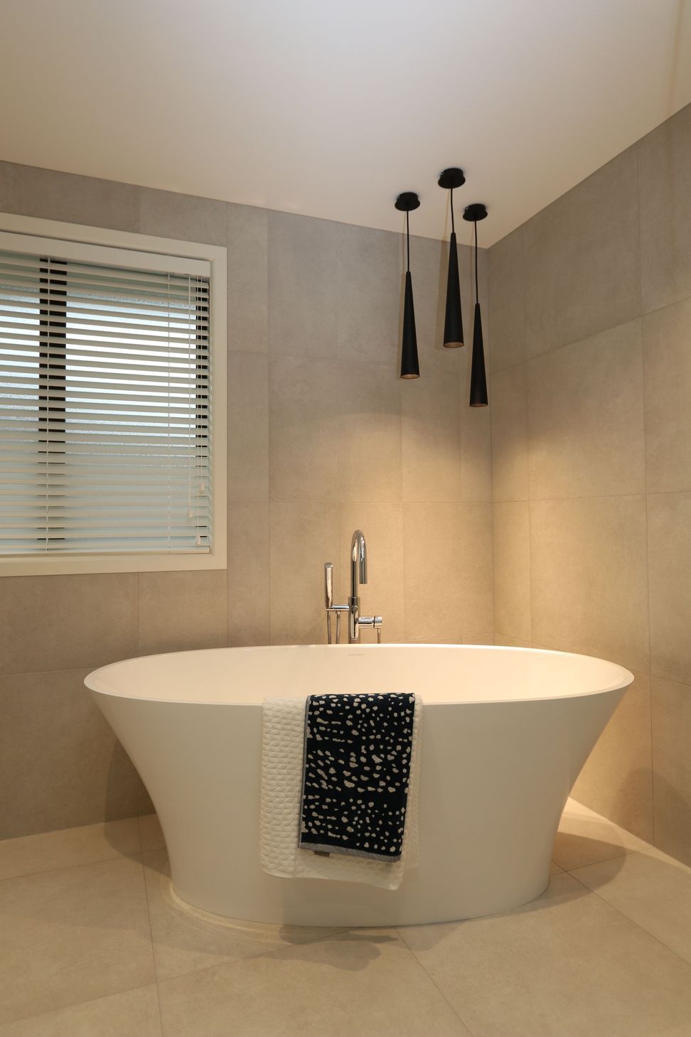 The main bathroom in this clients home features a matching theme with the same feature bath creating a statement with the gorgeous free-standing bath filler.