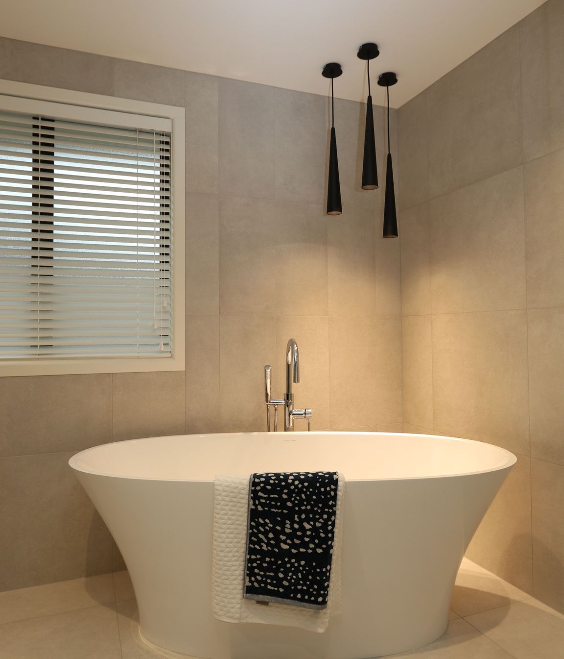 The main bathroom in this clients home features a matching theme with the same feature bath creating a statement with the gorgeous free-standing bath filler.