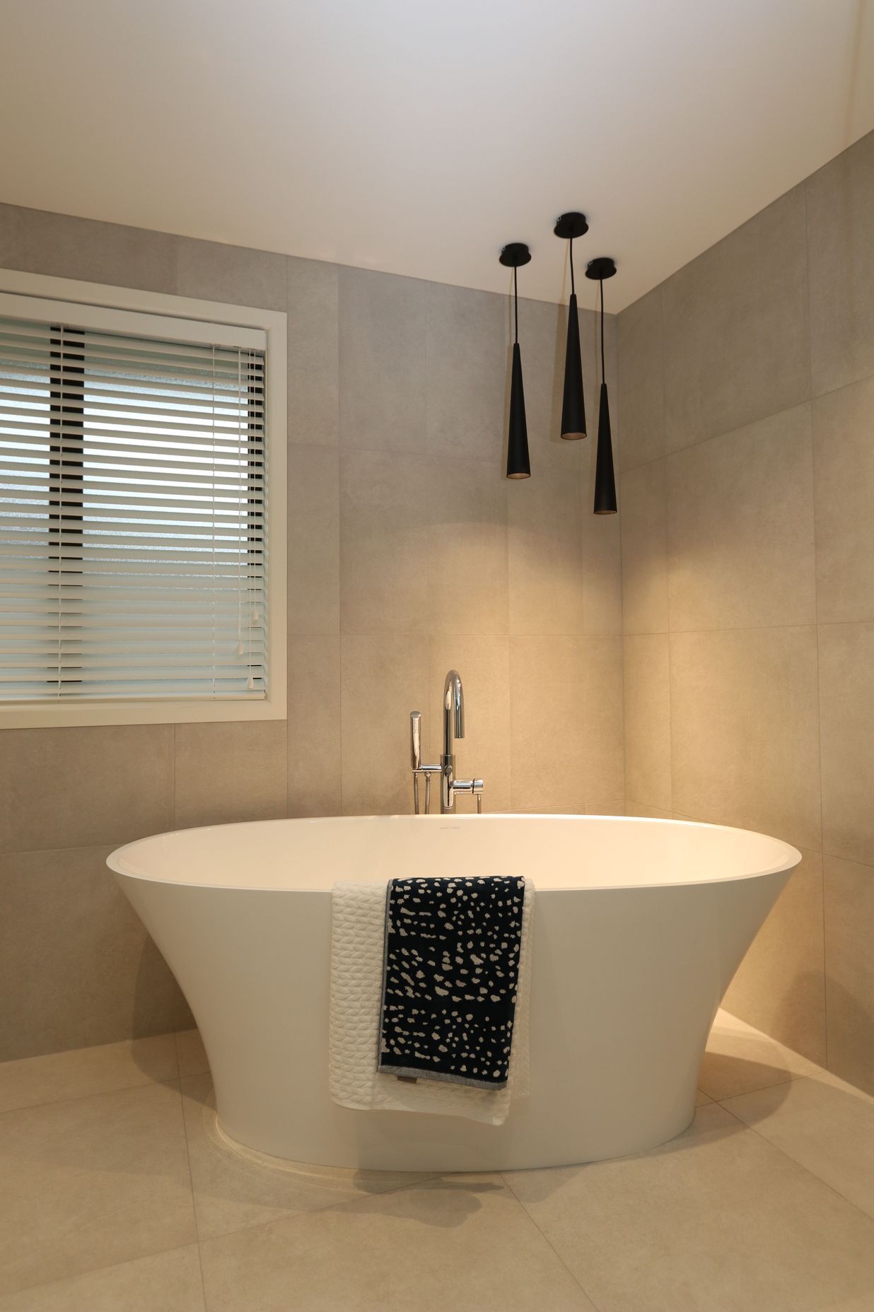 The main bathroom in this clients home features a matching theme with the same feature bath creating a statement with the gorgeous free-standing bath filler.