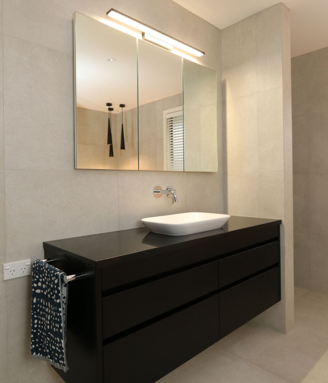 Recessed mirror cabinets in their main bathroom provides discreet storage space for the whole family without intruding on the spacious area.