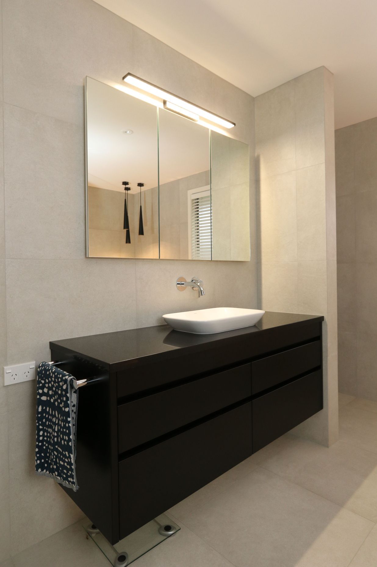 Recessed mirror cabinets in their main bathroom provides discreet storage space for the whole family without intruding on the spacious area.