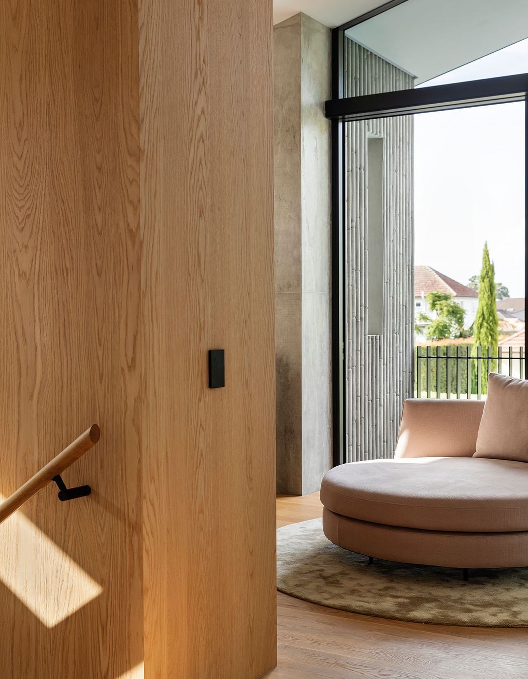 Upstairs, a pink circle sofa provides a dramatic centrepiece in the study area.