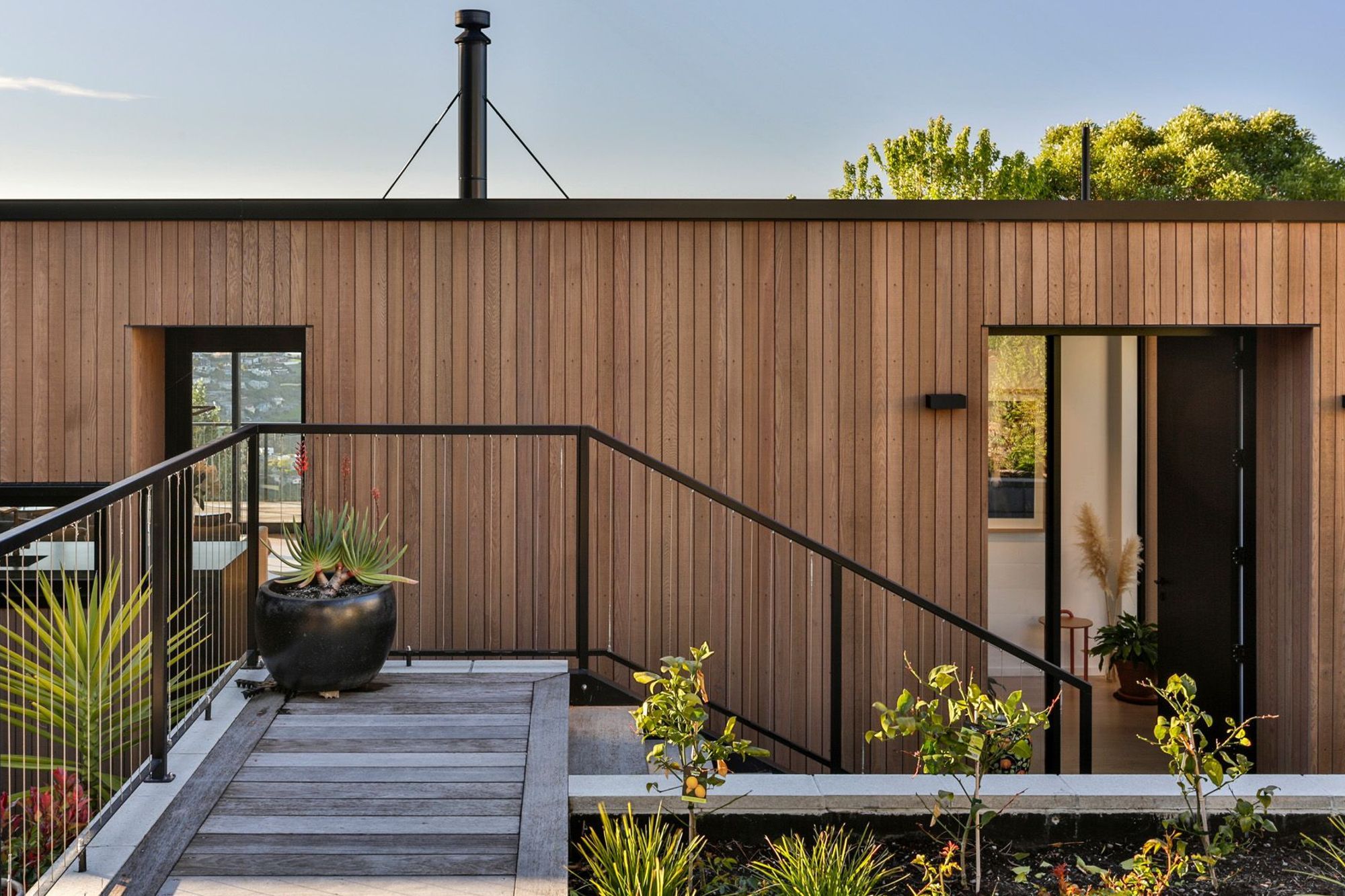 Sitting on a steep and challenging hill site, the front entrance is via stairs from the driveway above.