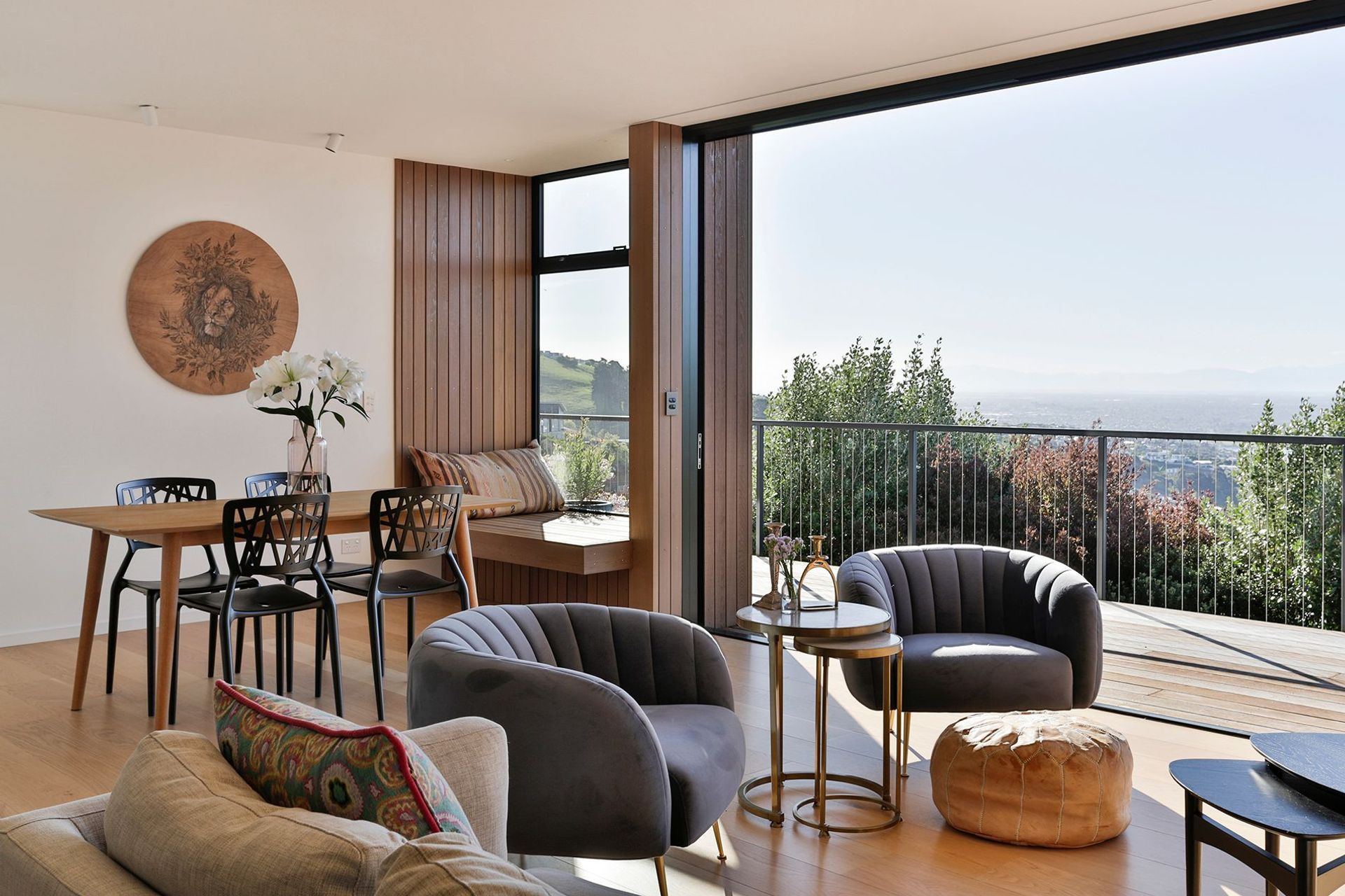 The open-plan living and dining area feature floor-to-ceiling stacking doors that slide back into recesses in the walls.