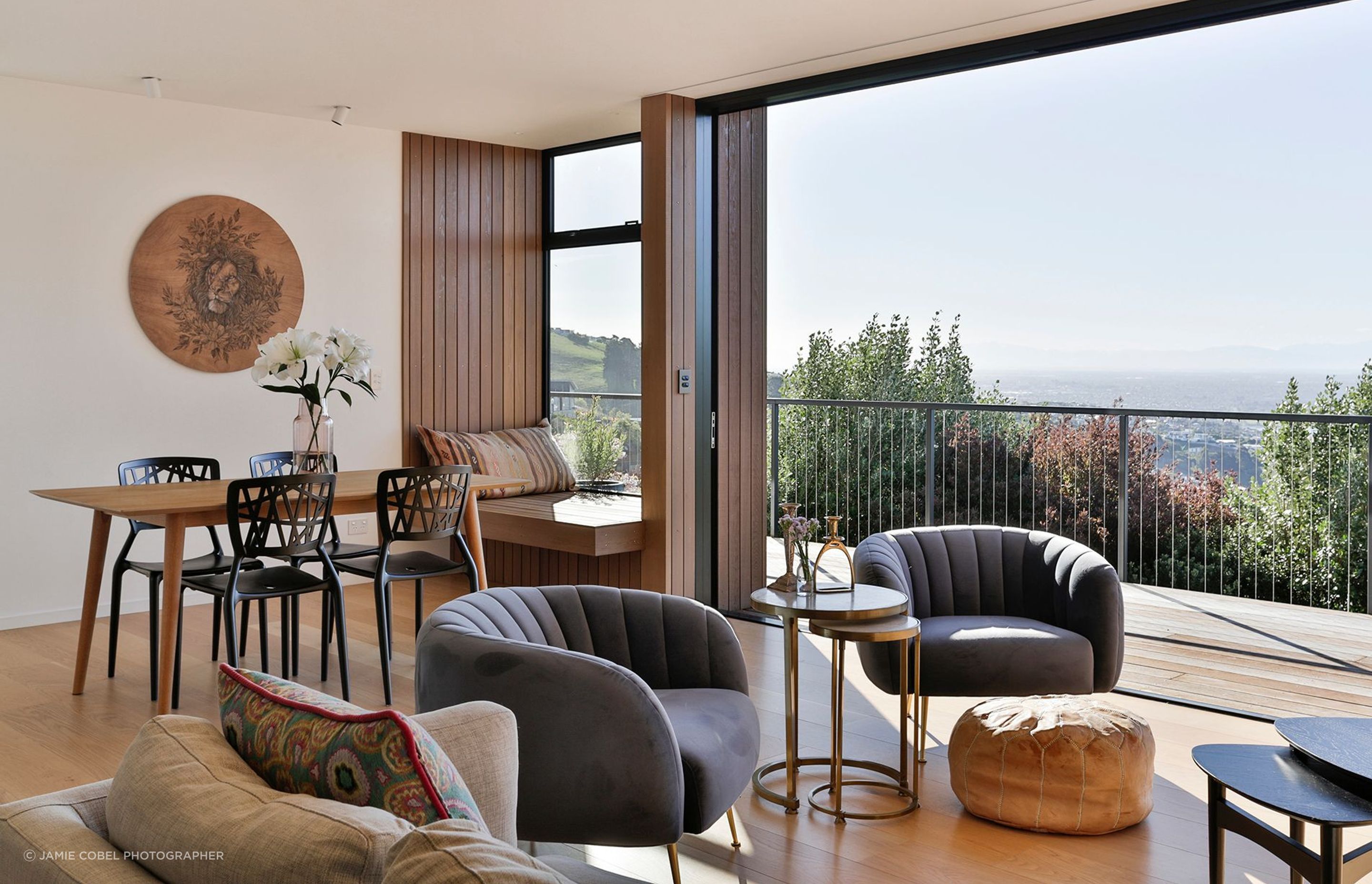 The open-plan living and dining area feature floor-to-ceiling stacking doors that slide back into recesses in the walls.