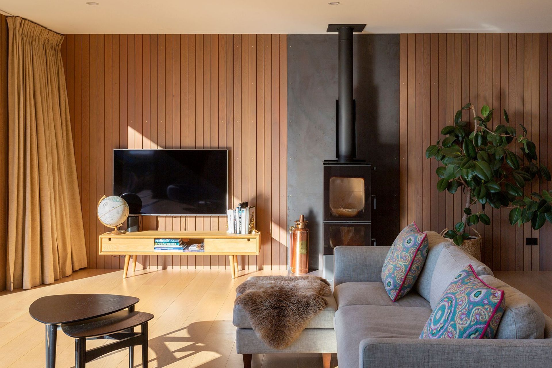 Cedar panelling lines the back wall of the lounge area and oak flooring runs throughout, adding warmth to the space. 