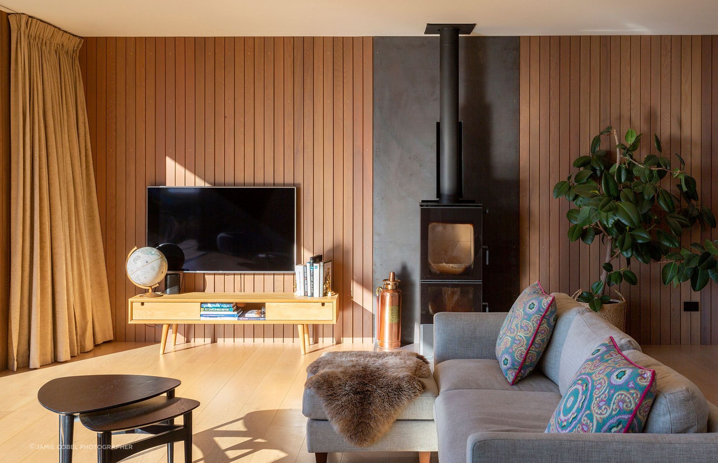 Cedar panelling lines the back wall of the lounge area and oak flooring runs throughout, adding warmth to the space. 