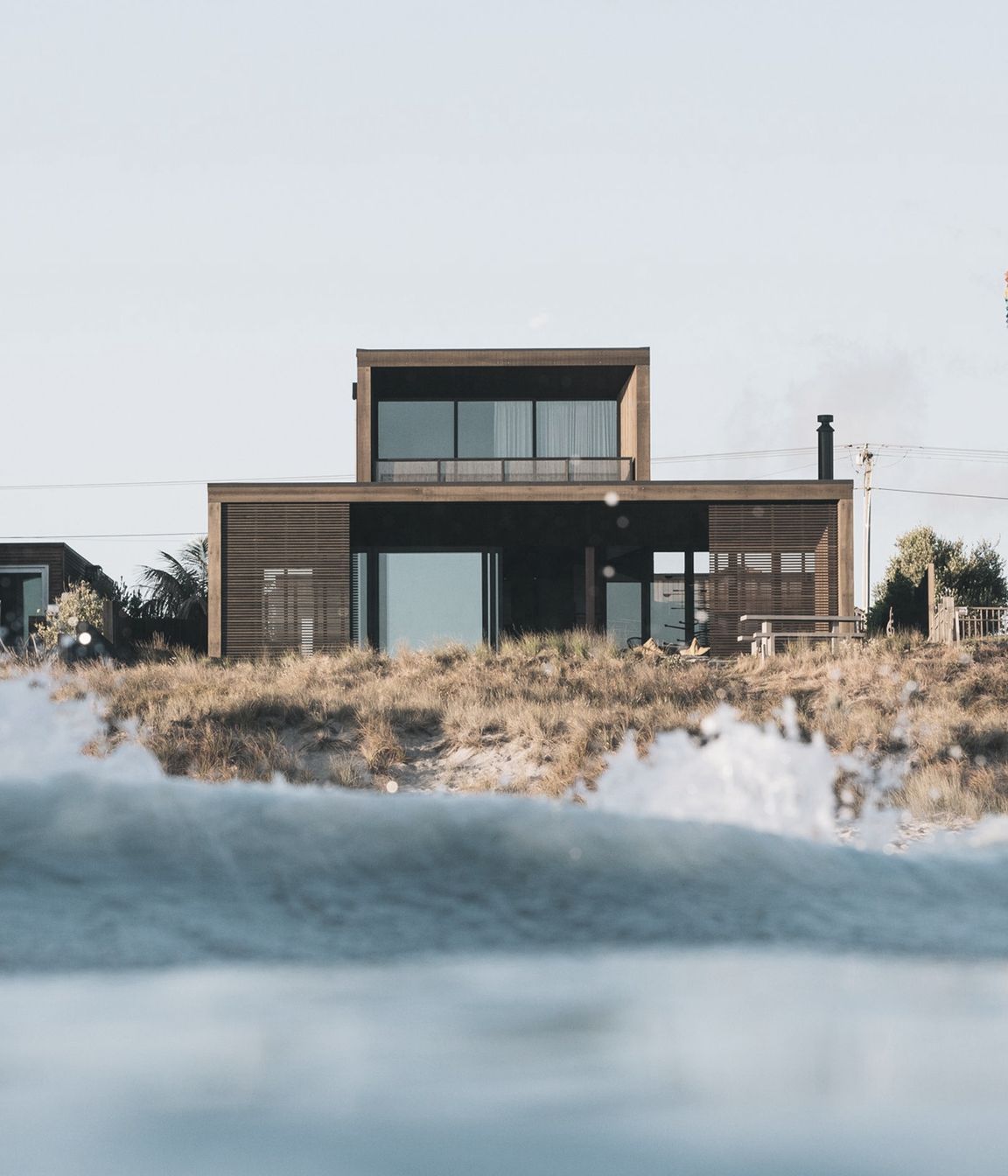 Sitting within the dunes on Papamoa Beach, Tauranga, this home is as close to beachfront as you can get. 