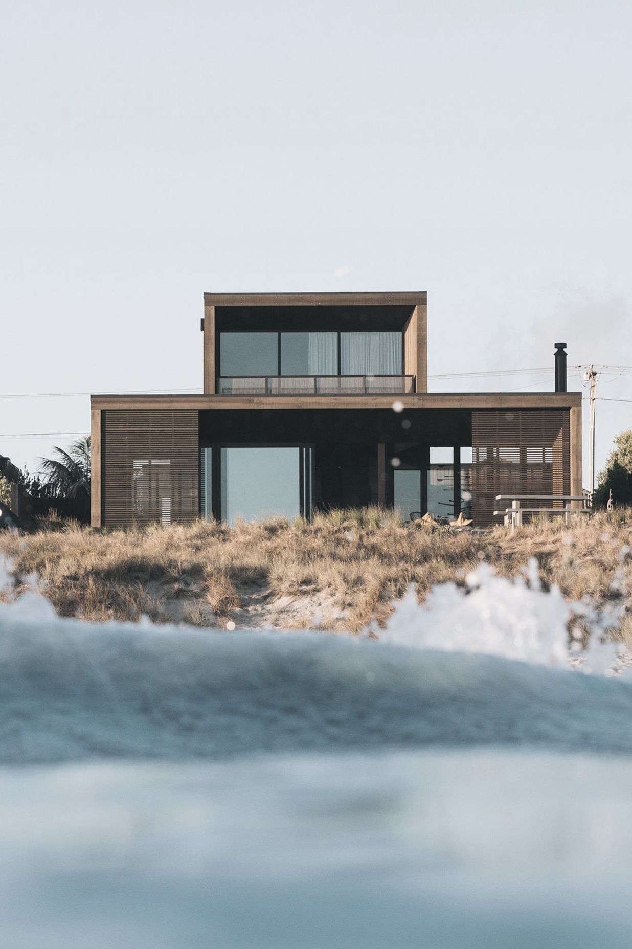 Sitting within the dunes on Papamoa Beach, Tauranga, this home is as close to beachfront as you can get.
