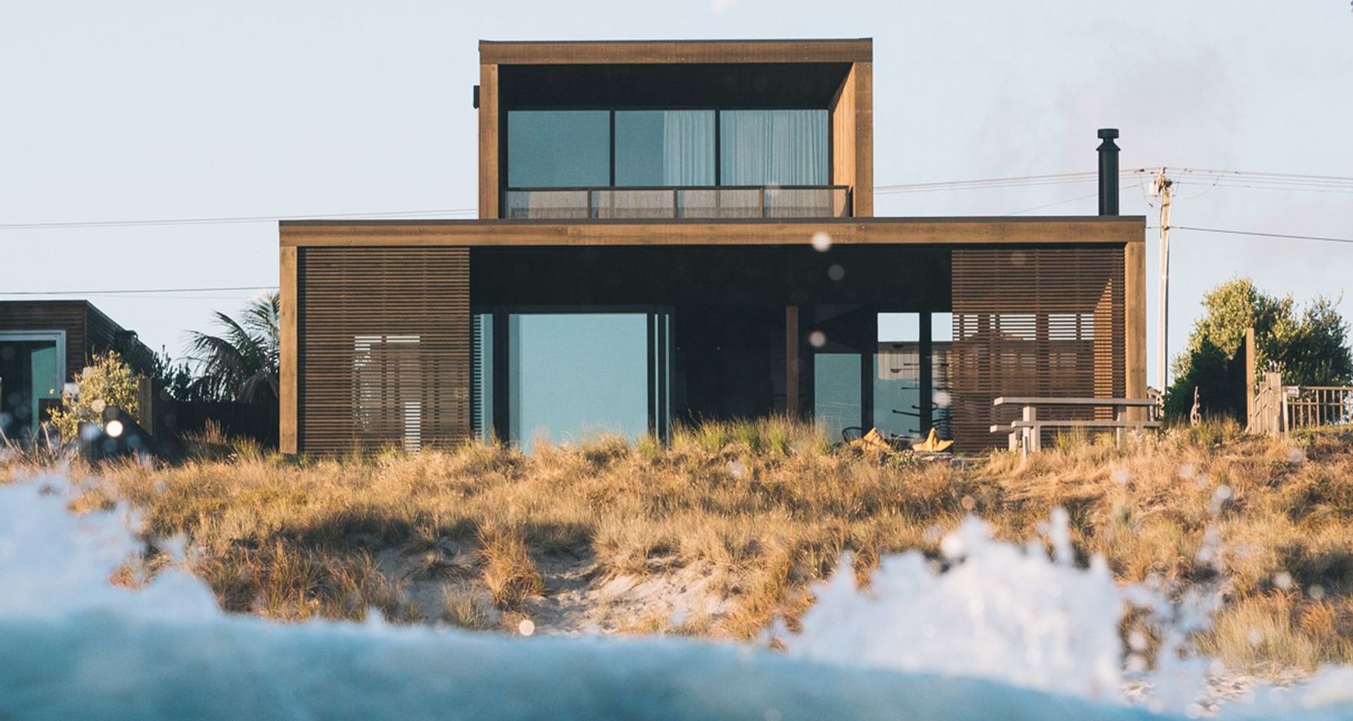 Sitting within the dunes on Papamoa Beach, Tauranga, this home is as close to beachfront as you can get.