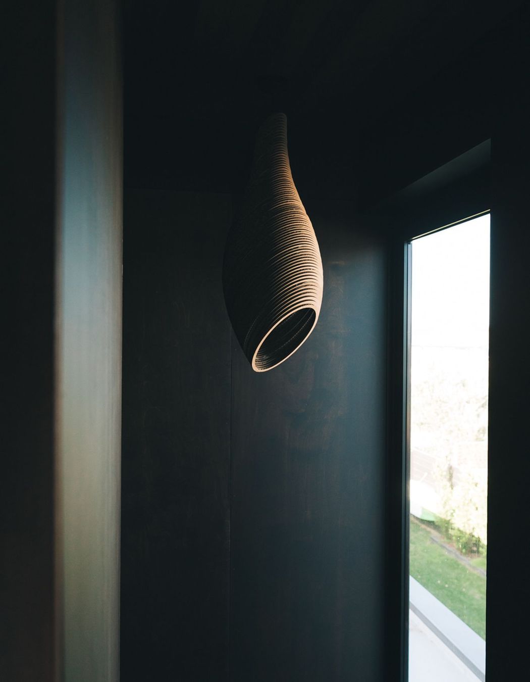 A light feature made of laser-cut cardboard hangs above the stairwell.