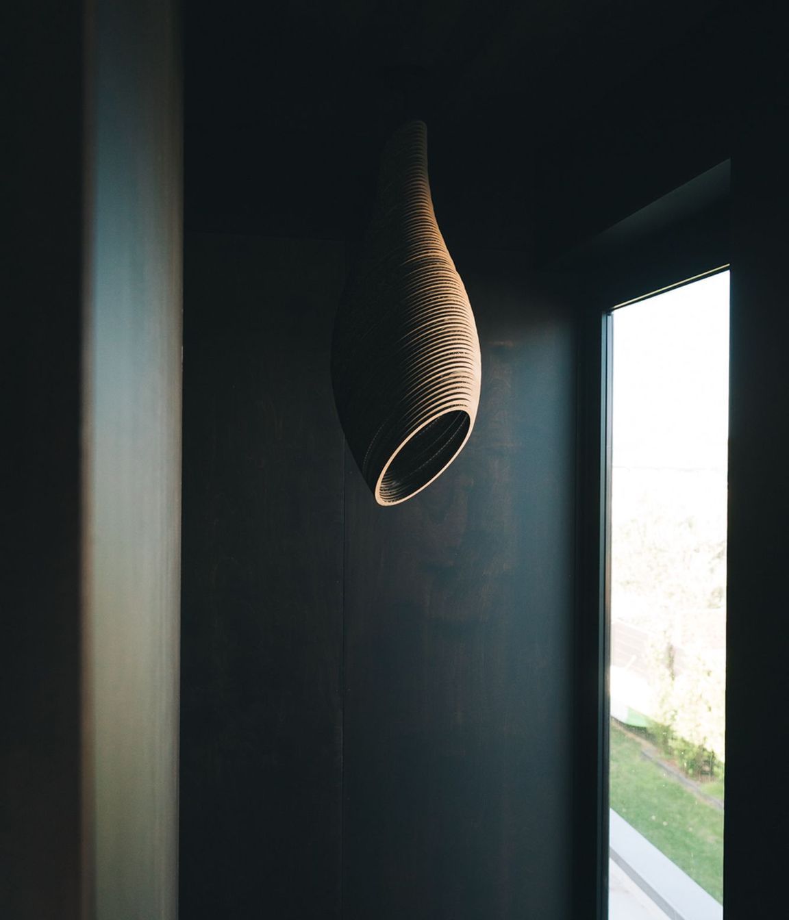 A light feature made of laser-cut cardboard hangs above the stairwell.