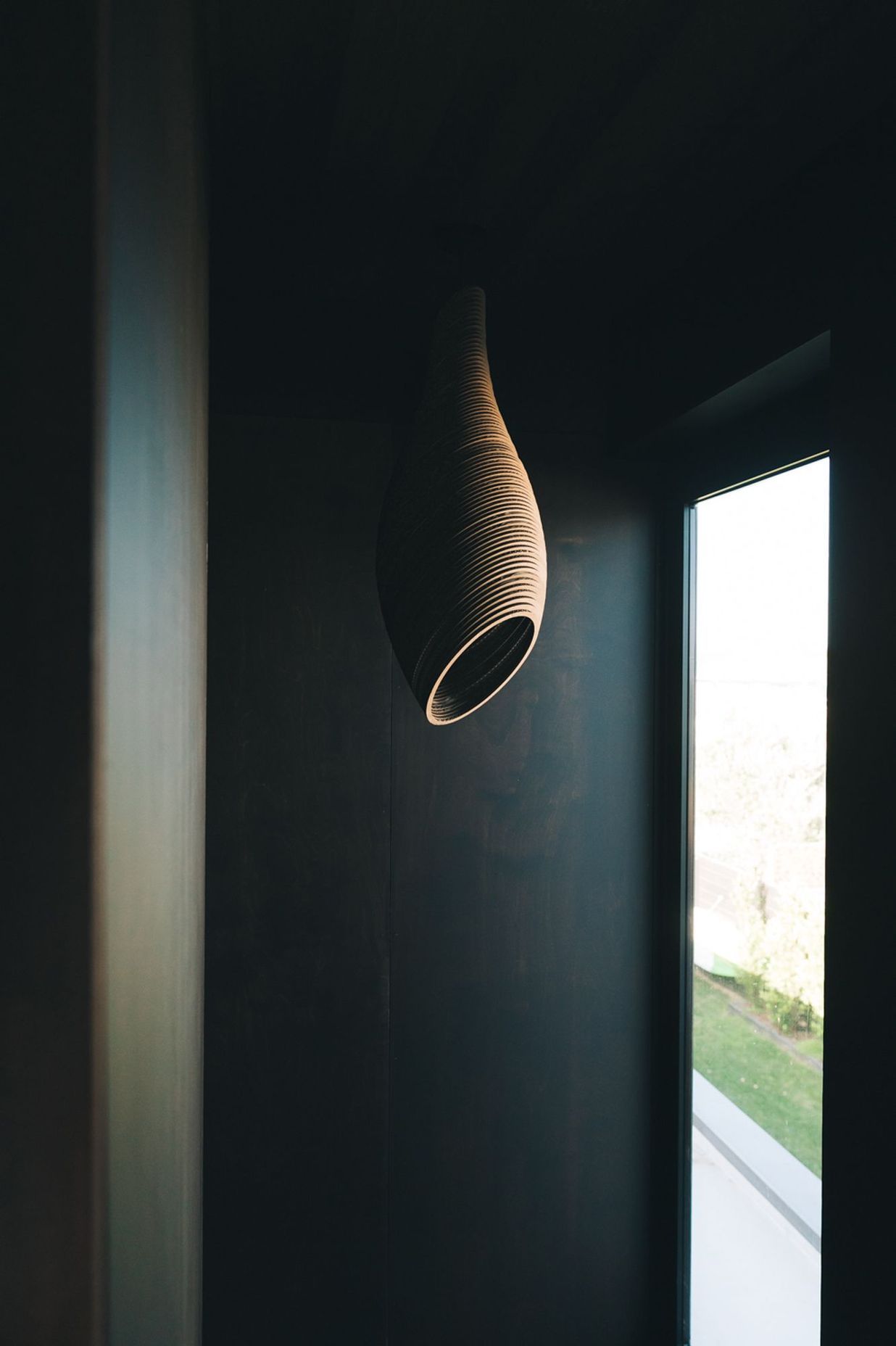 A light feature made of laser-cut cardboard hangs above the stairwell.