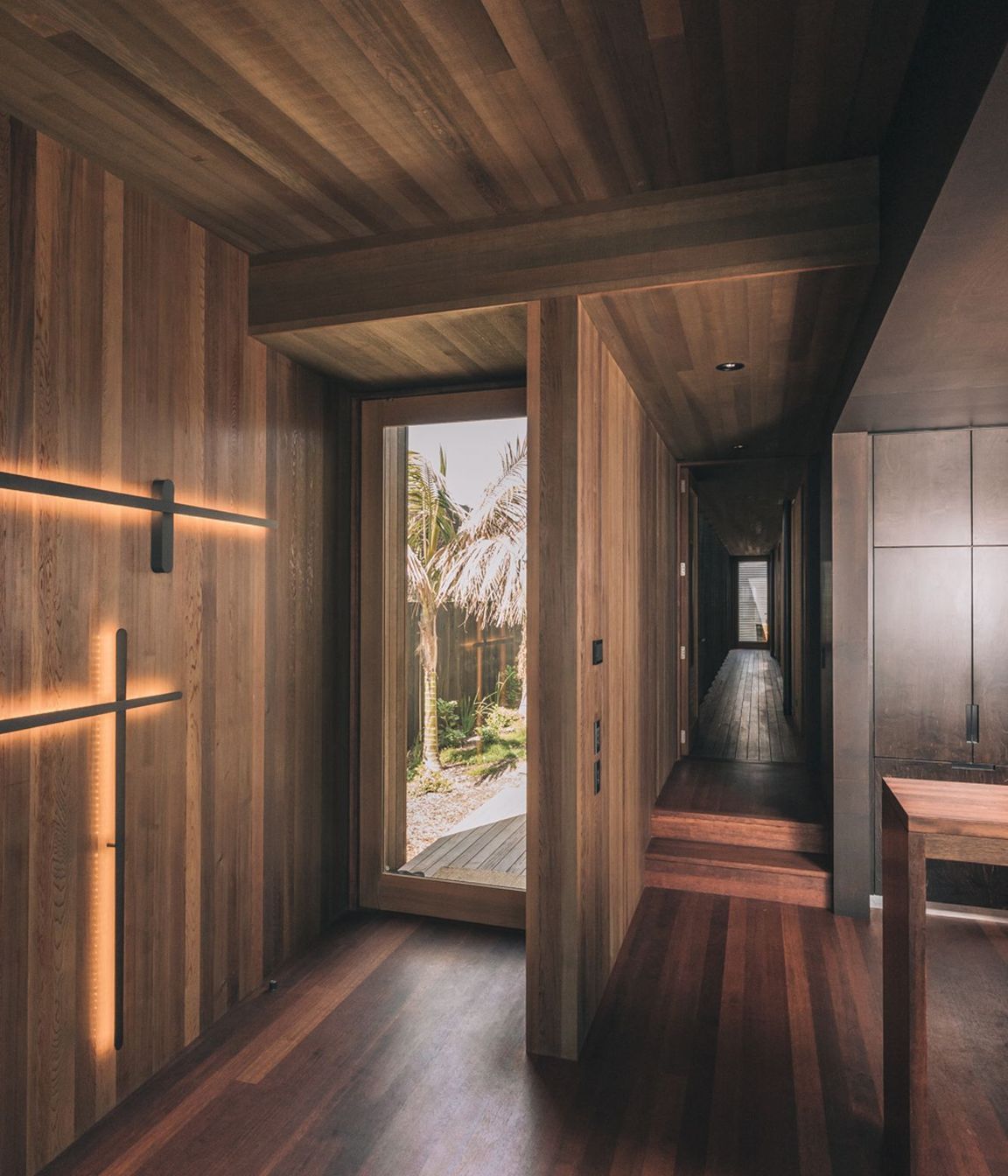 The interiors are dominanted by rich timber and deep tones, unusual for beachside homes.
