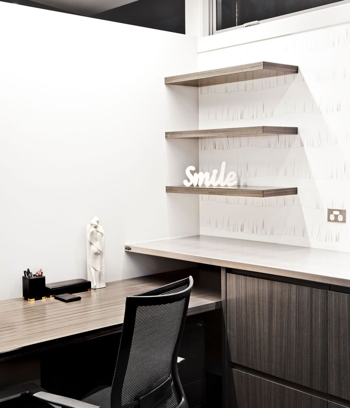 An understated office...with wallpaper to create a playful element to a practical space...and make you smile.