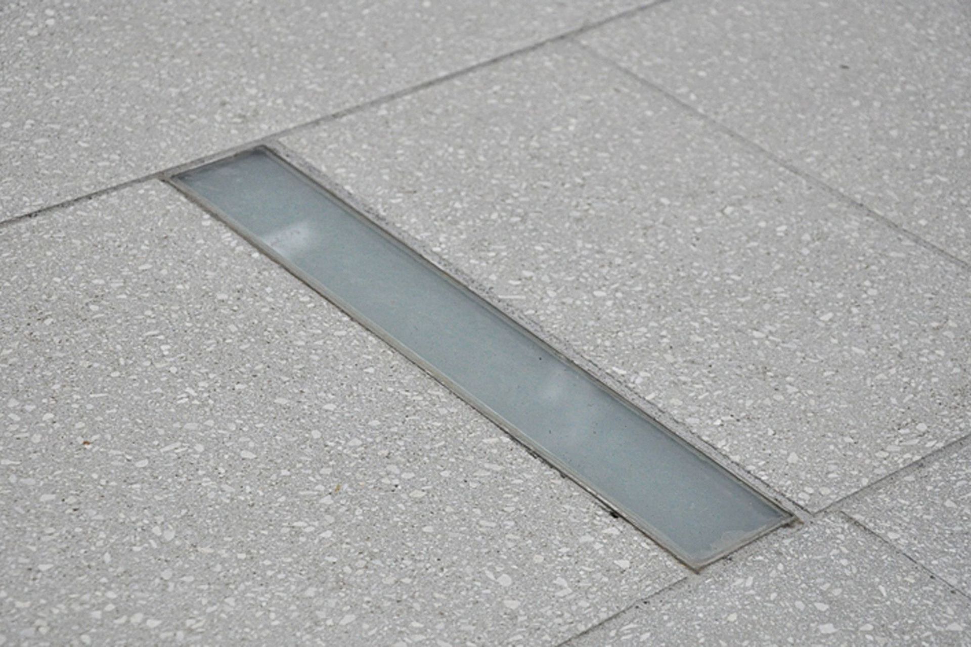 Inground slot shaped LED lighting was custom designed and manufactured for this Khandallah courtyard garden