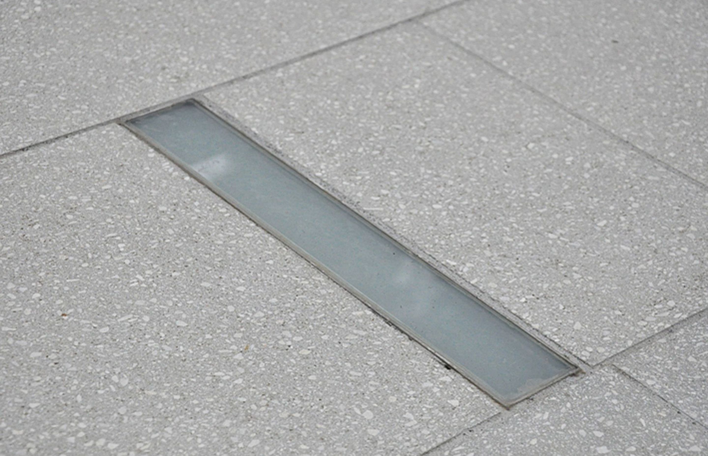 Inground slot shaped LED lighting was custom designed and manufactured for this Khandallah courtyard garden