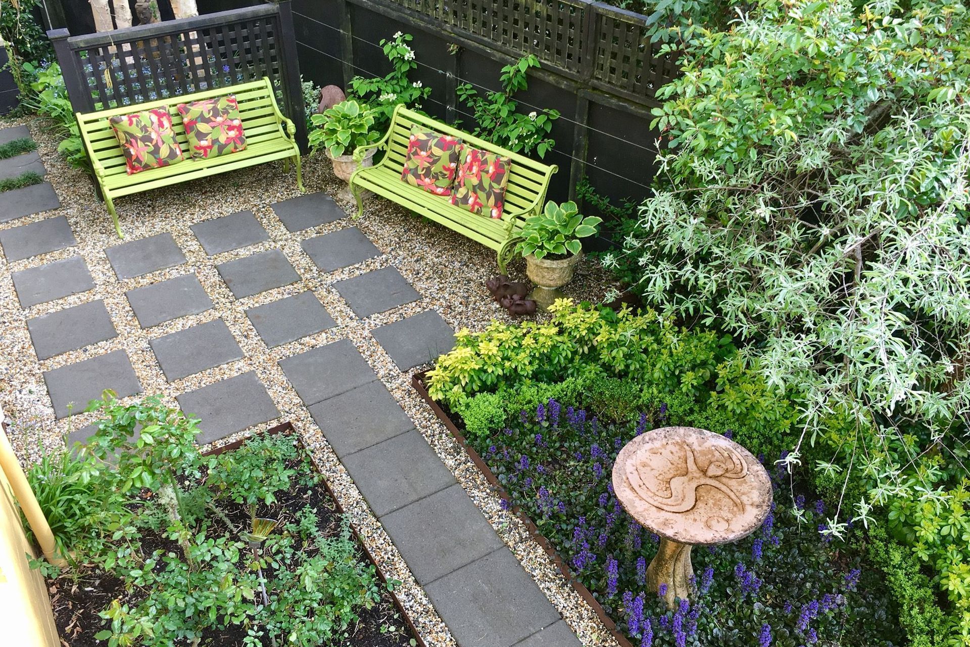 Paving set into gravel with bench seating