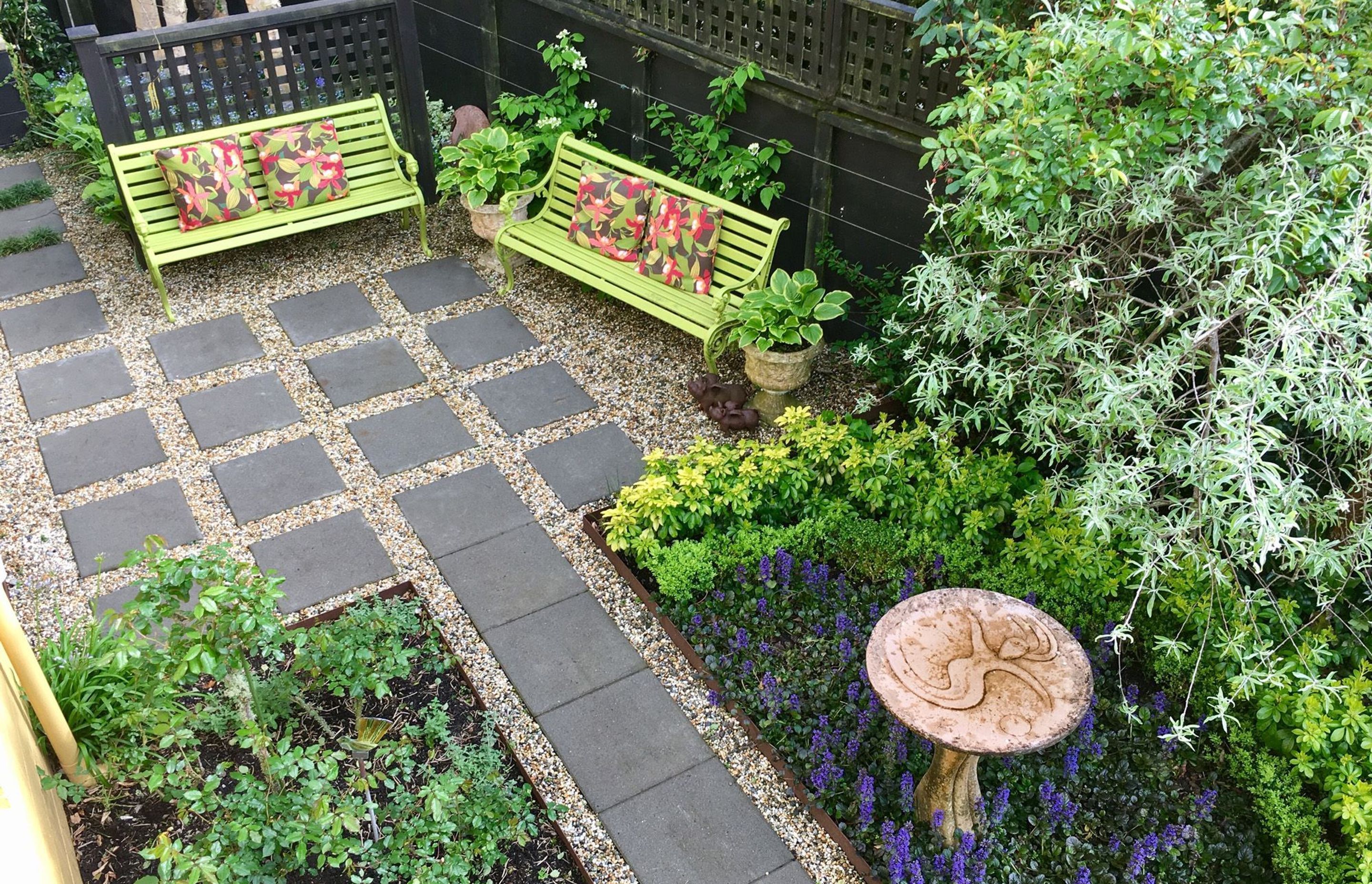 Paving set into gravel with bench seating