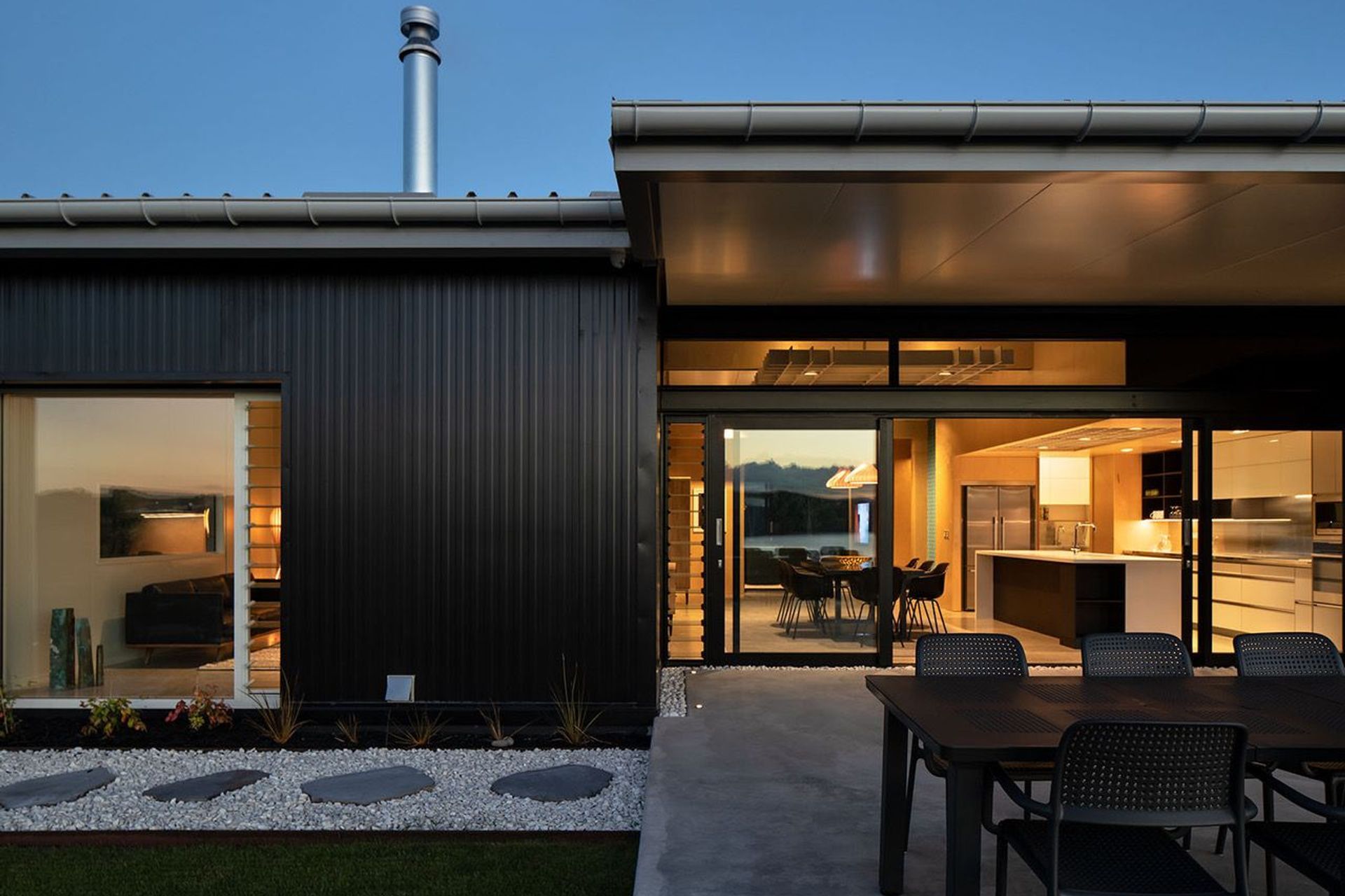 A landscaped walkway surrounds the house, interjected by terraced areas for entertaining and sitting and looking at the view. Photograph: Simon Devitt.