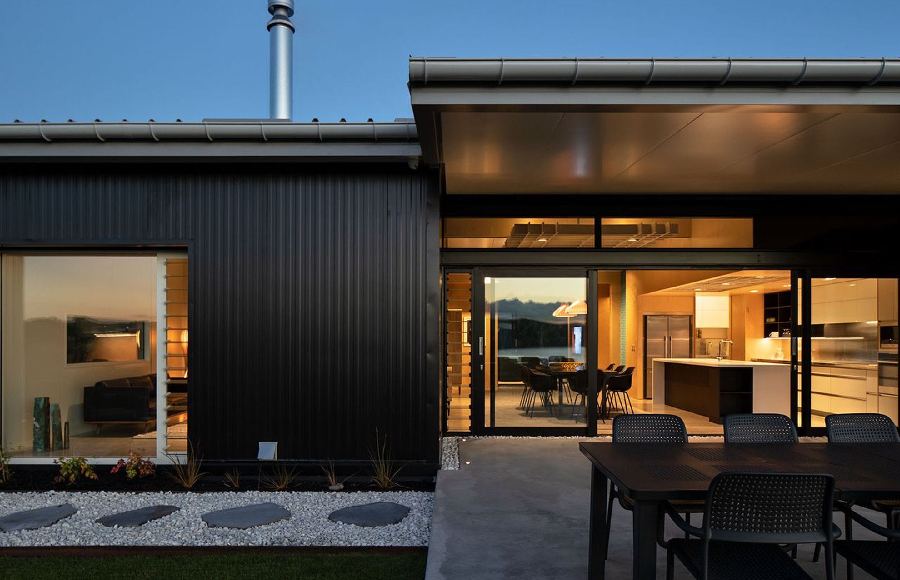 A landscaped walkway surrounds the house, interjected by terraced areas for entertaining and sitting and looking at the view. Photograph: Simon Devitt.