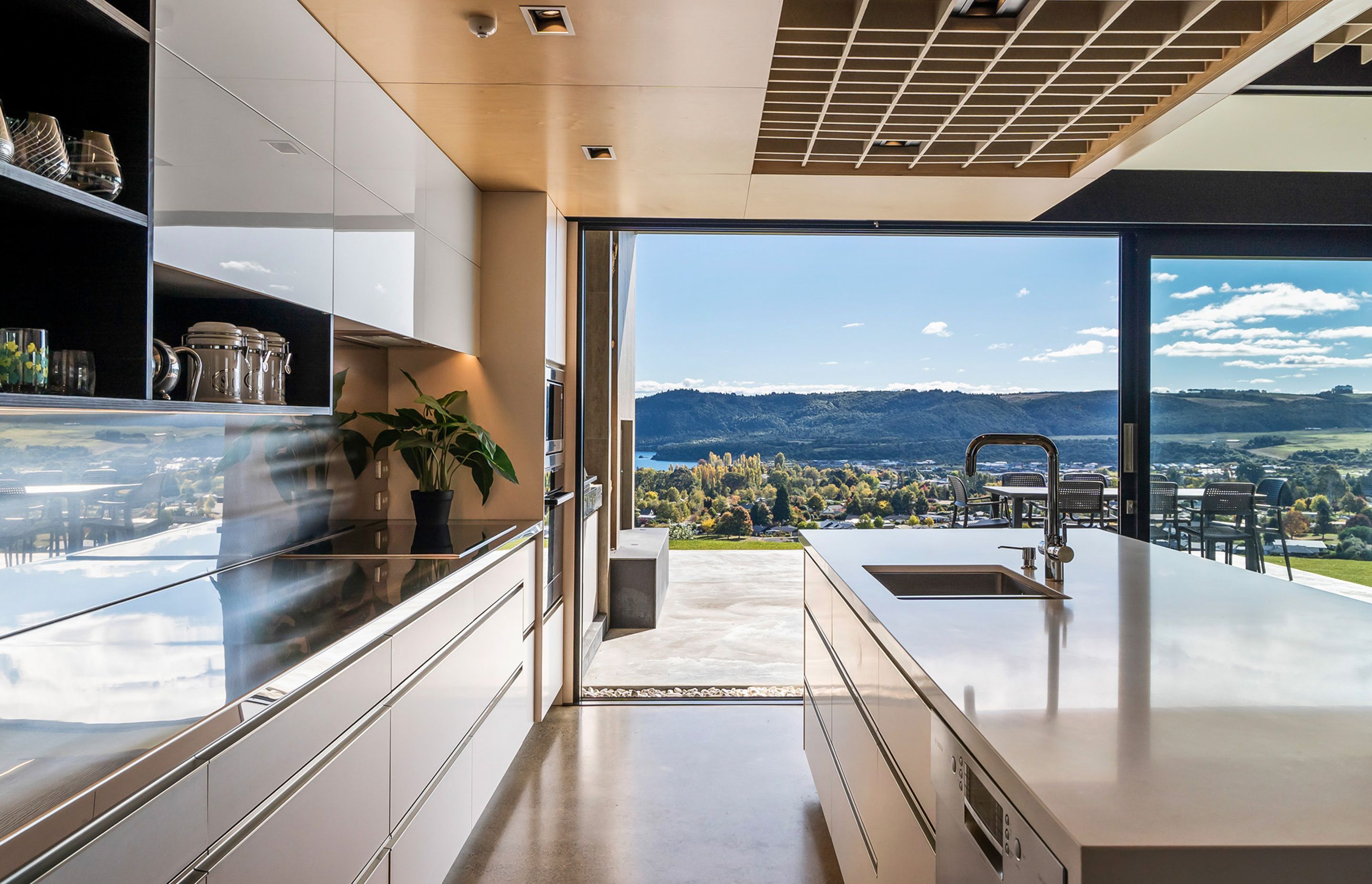 The highly functional kitchen features 'this view' from the kitchen sink – say no more! Photograph: ArchiPro.