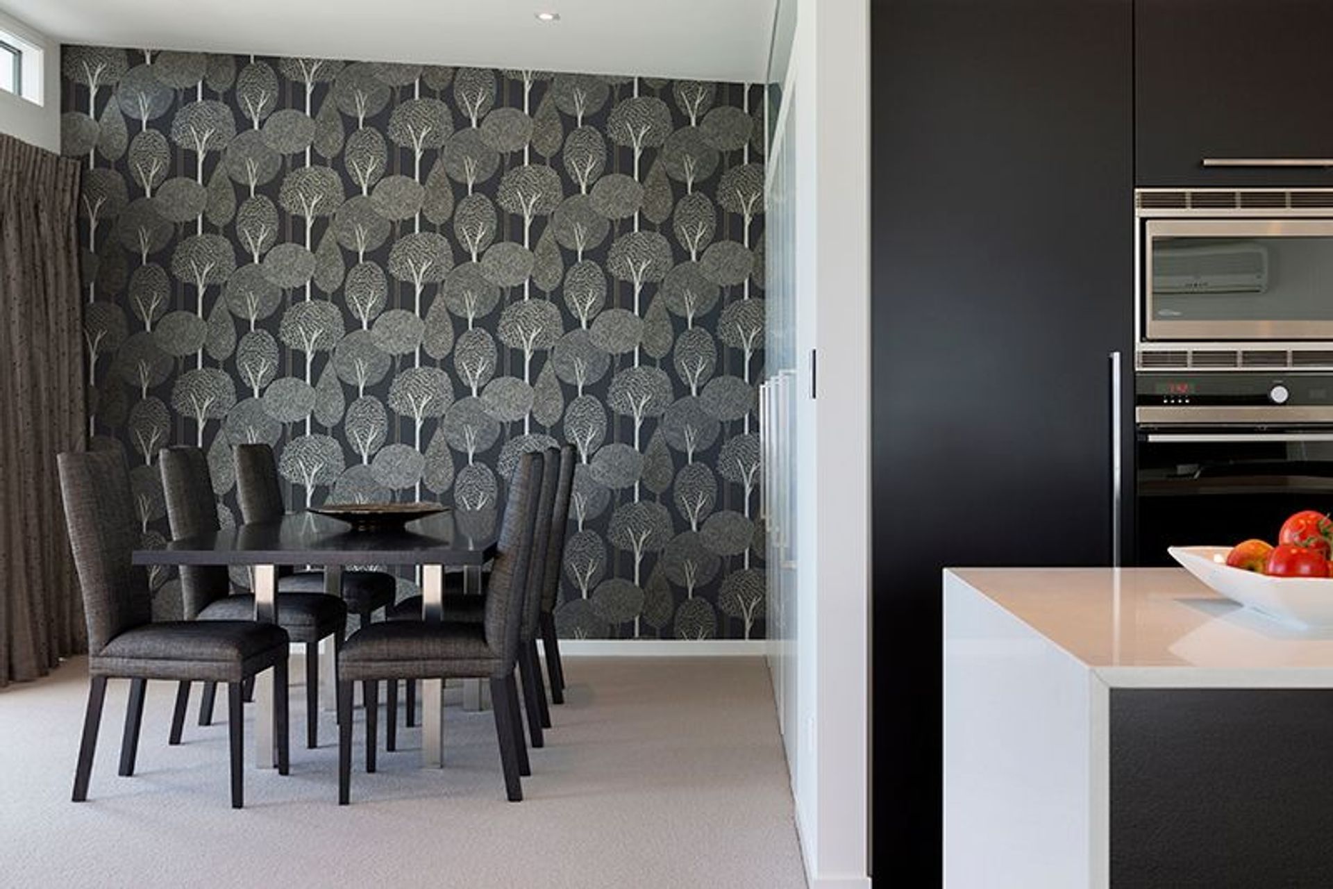 Dining room features Harlequin wallpaper and David Shaw dining chairs. Office space concealed behind bifold doors to the right
