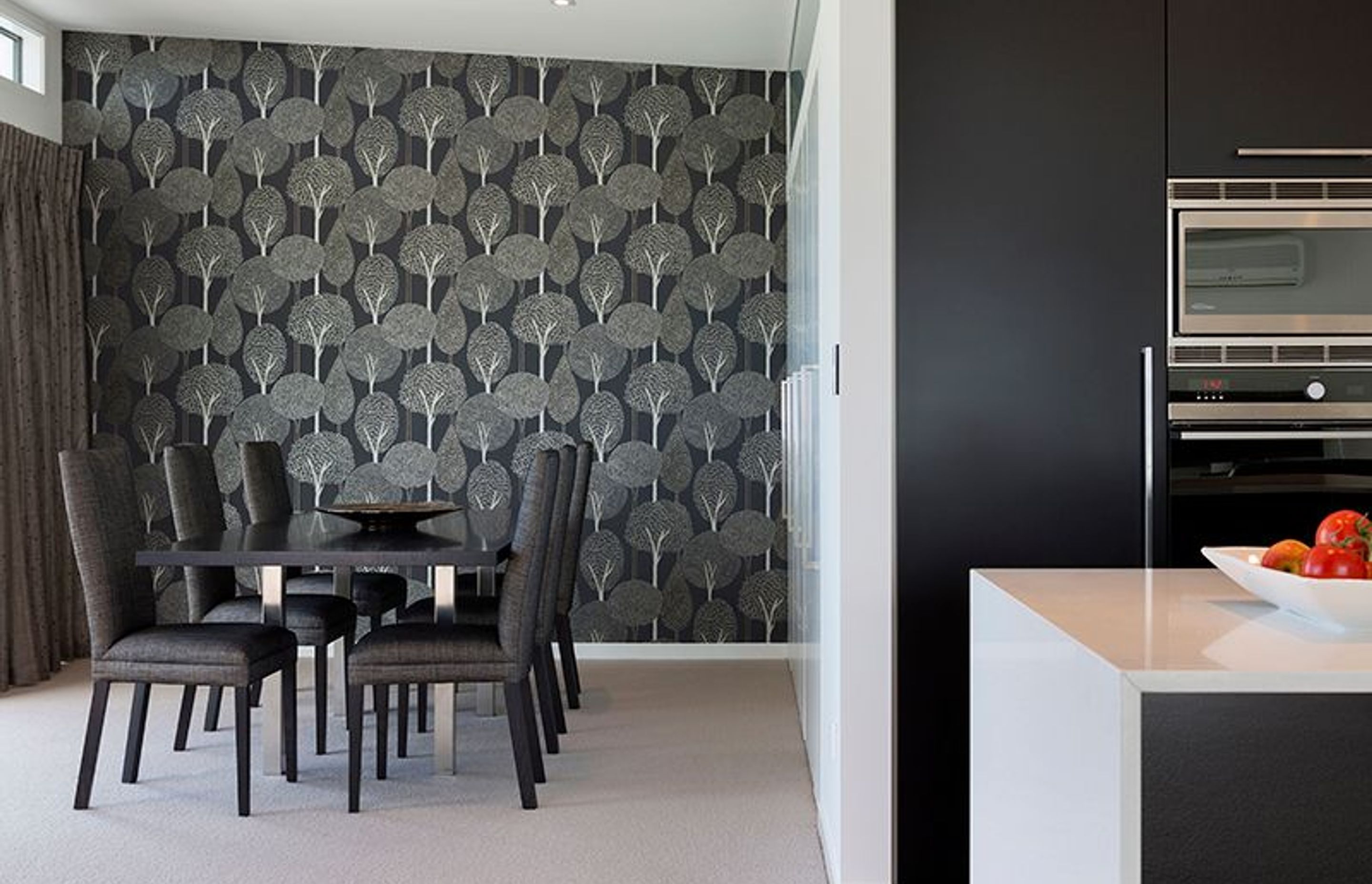 Dining room features Harlequin wallpaper and David Shaw dining chairs. Office space concealed behind bifold doors to the right
