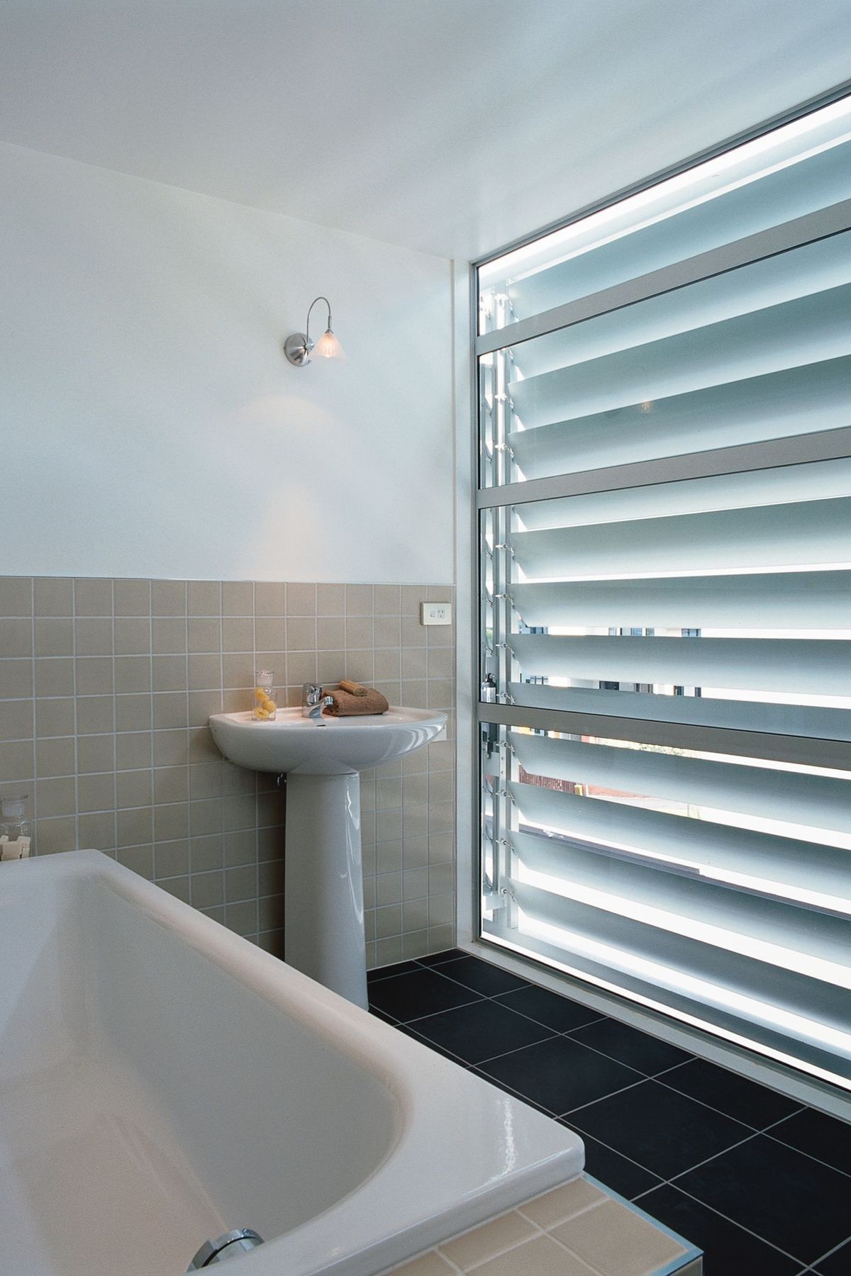 The third floor full bathroom is screened from the streetscape elevation by an adjustable Louvre Tec screen