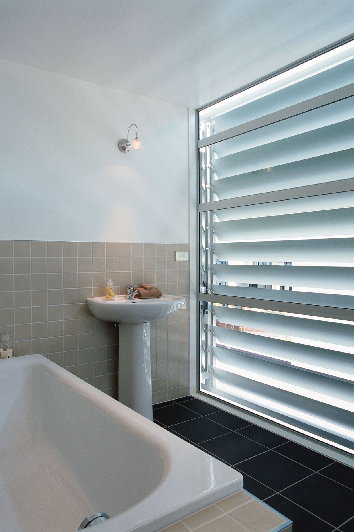 The third floor full bathroom is screened from the streetscape elevation by an adjustable Louvre Tec screen