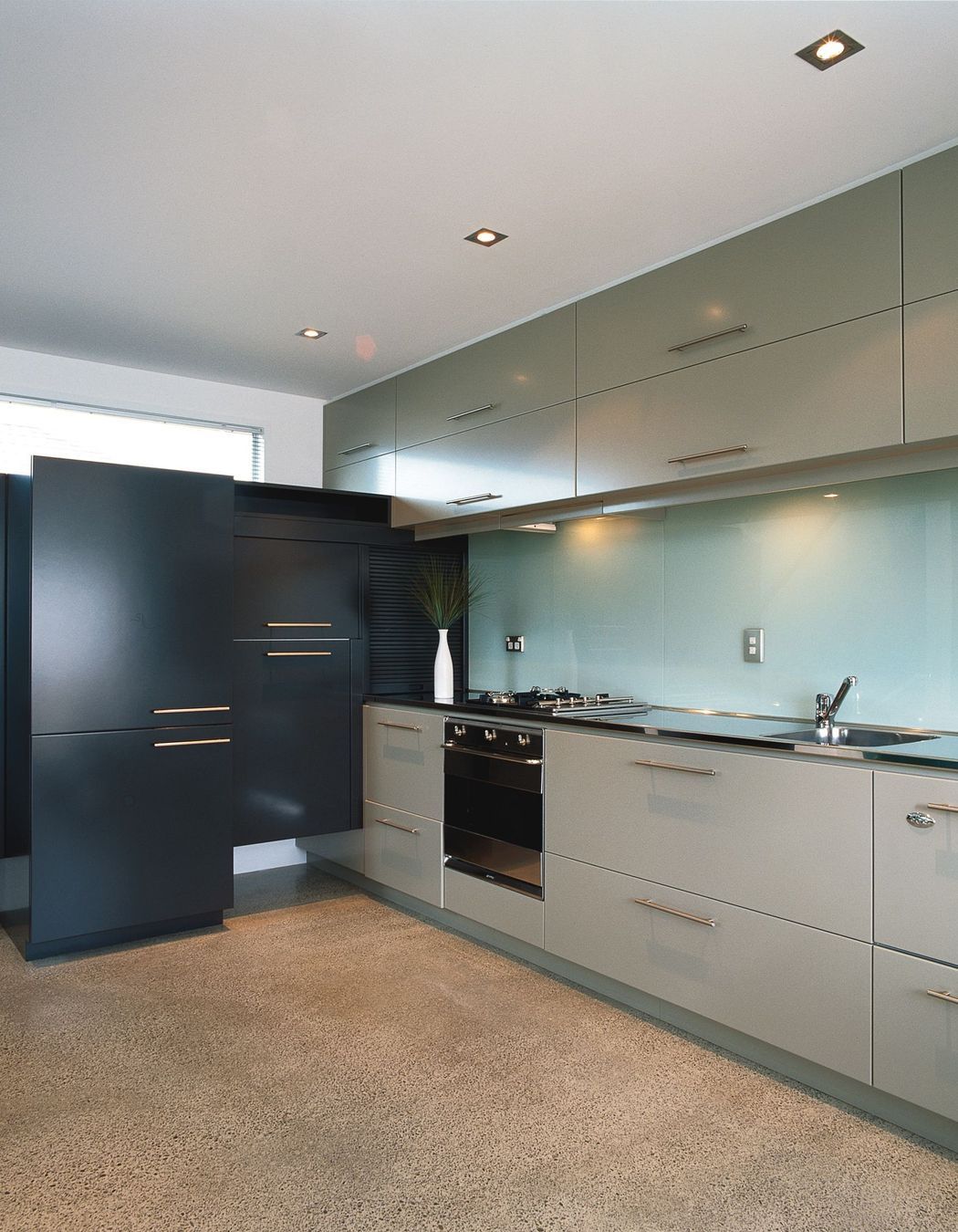 Compact apartment style kitchen with built in cabinetry for appliances and storage